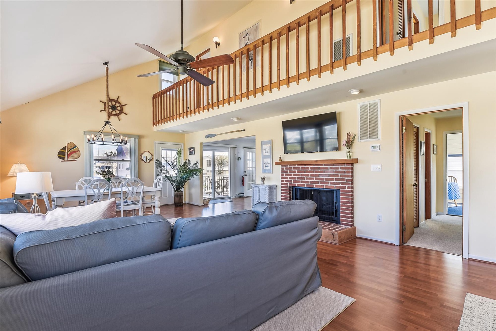 Settle into your spacious living room with soaring ceilings, charming loft overlook, and cozy fireplace—perfect for gathering after a day of coastal adventures.