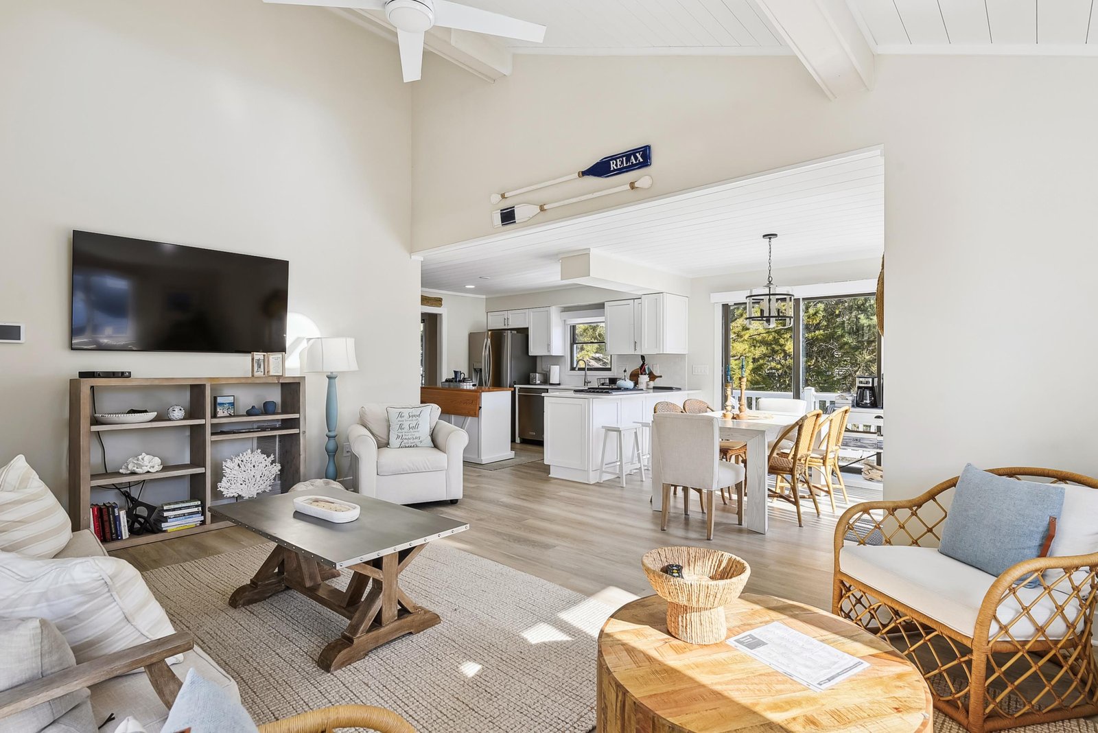 Sun-drenched coastal retreat with vaulted ceilings, open-plan living, and abundant natural light. Perfect for unwinding and gathering with comfortable seating and dining.