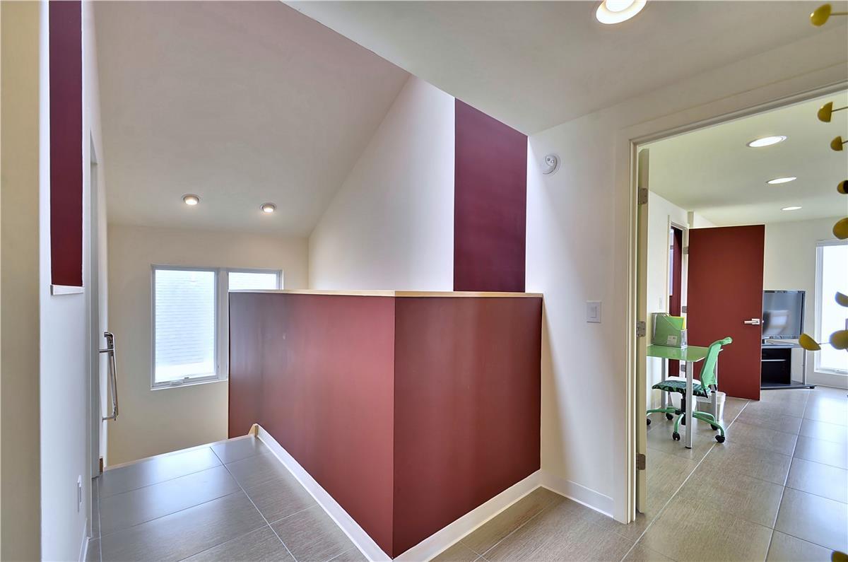Modern hallway connects you to the bright spaces throughout this contemporary home. Bold accent colors and thoughtful design make every corner inviting.