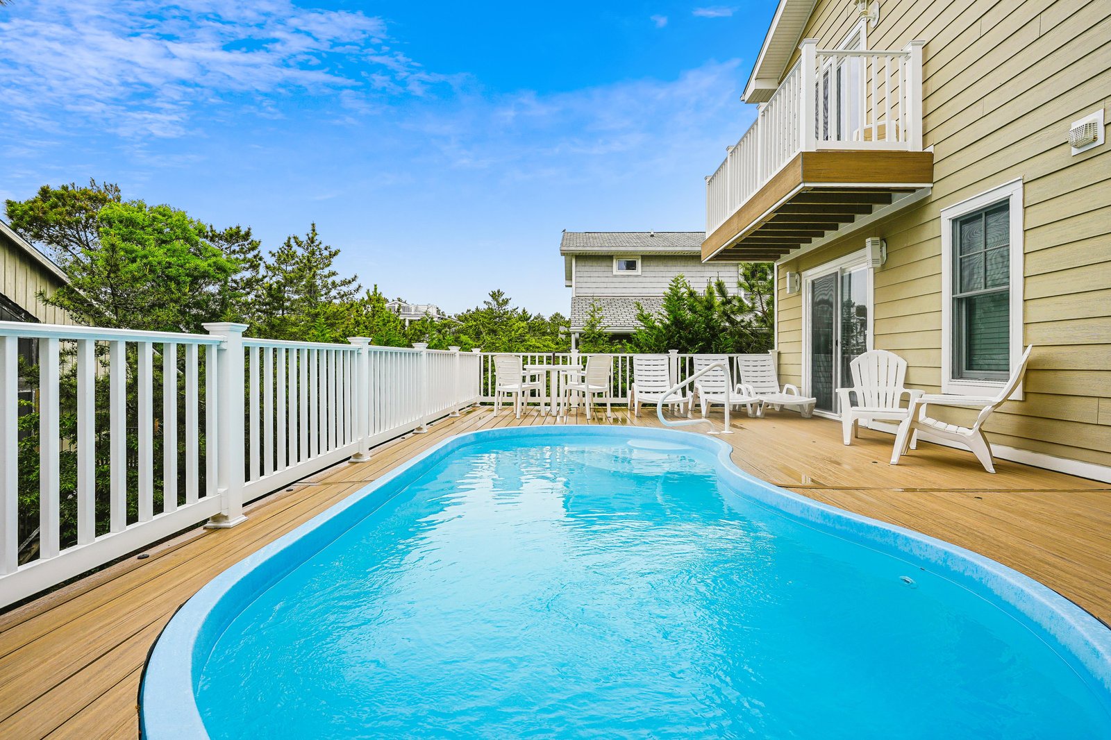 Your private deck oasis features a sparkling pool surrounded by sunny seating areas, perfect for laid-back afternoons under the open sky.