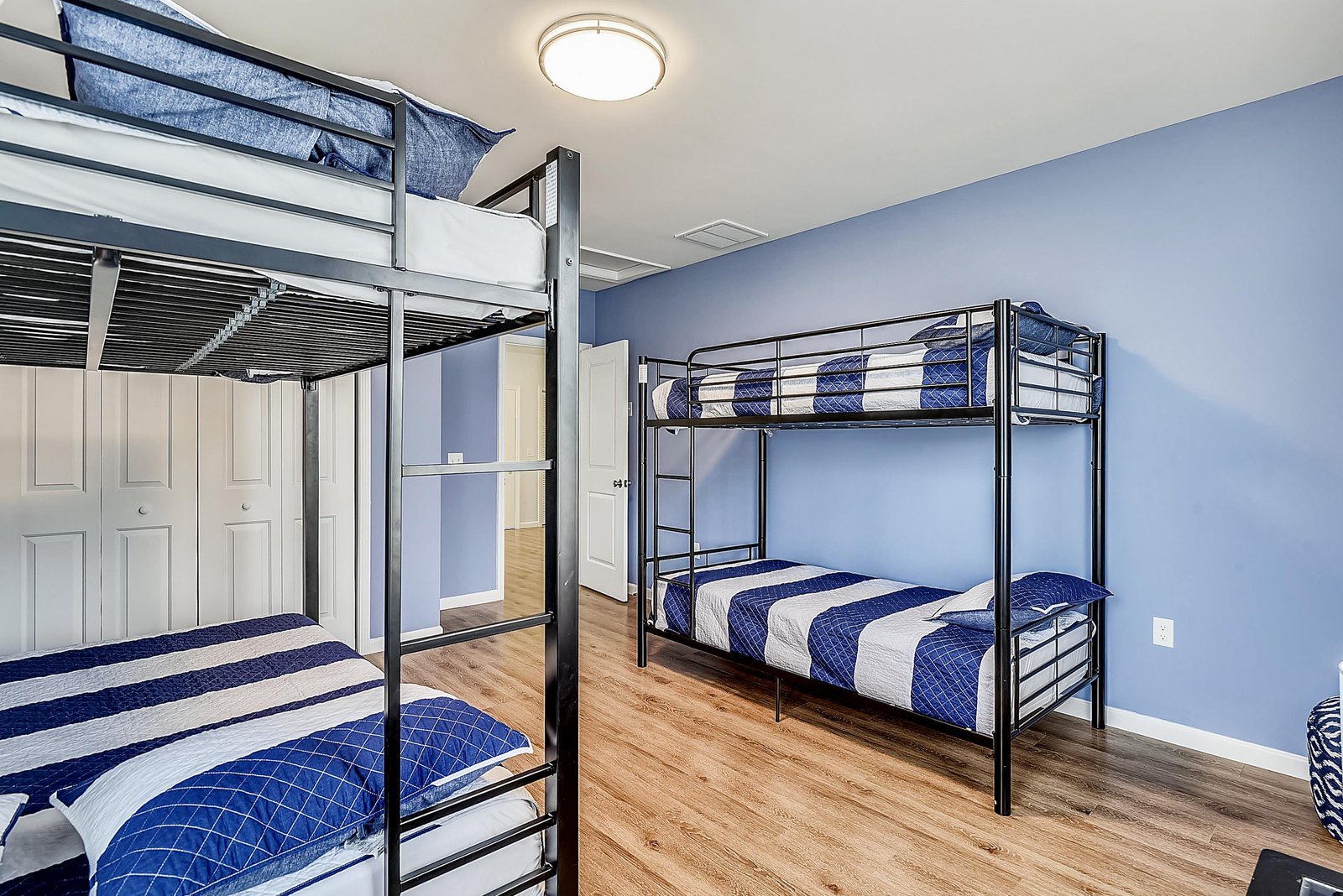 You'll find plenty of sleeping space in this bright bunk room, perfect for families or groups traveling together. The calming blue walls and comfortable bedding create a restful retreat.