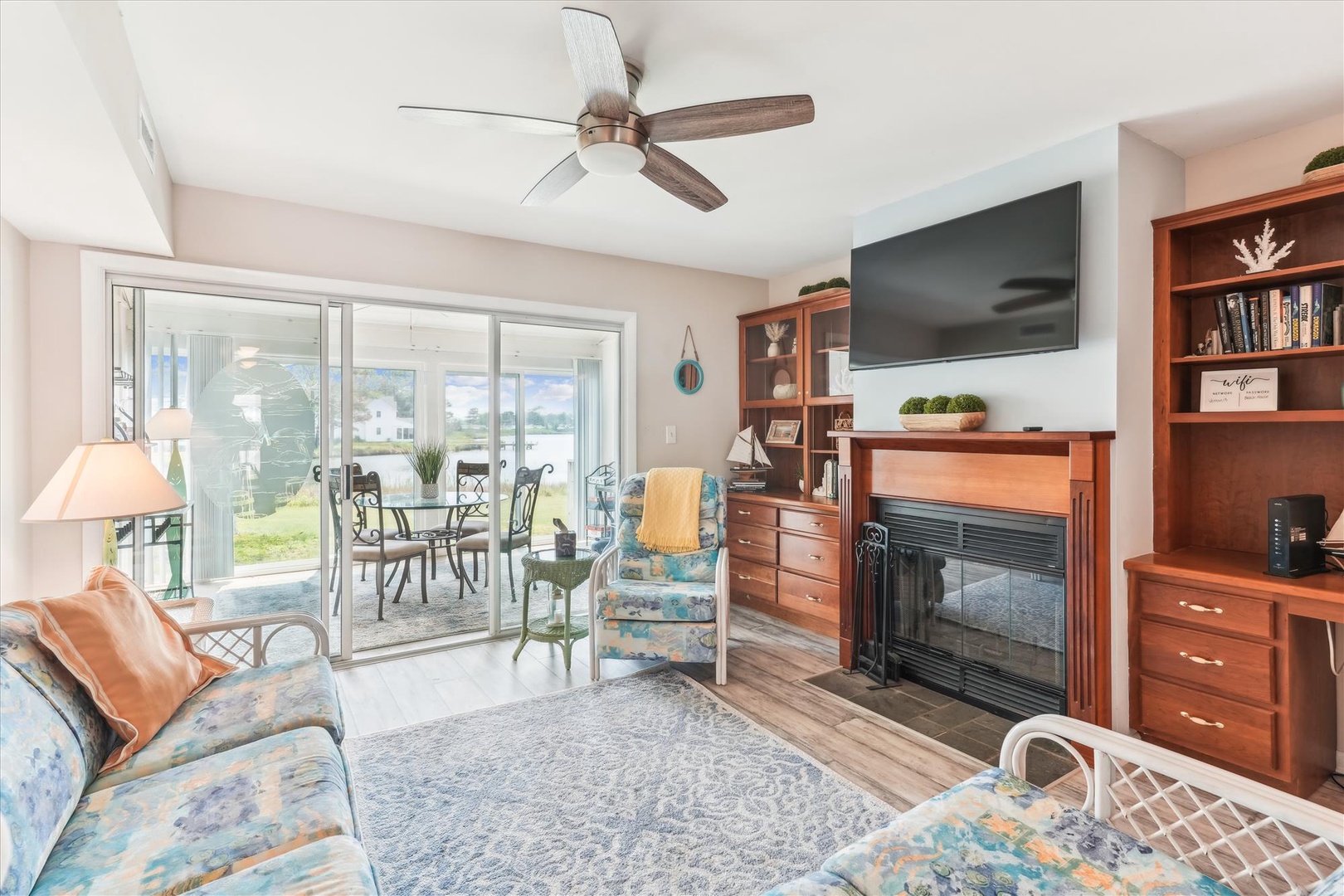 Relax in your bright living room with a cozy fireplace, ceiling fan, and sliding doors leading to a waterfront patio. Watch your favorite shows while enjoying lake views.