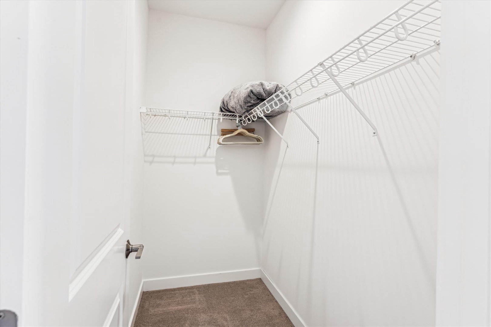 Your spacious walk-in closet features wire shelving and a convenient hanging rod to keep your wardrobe organized throughout your stay.