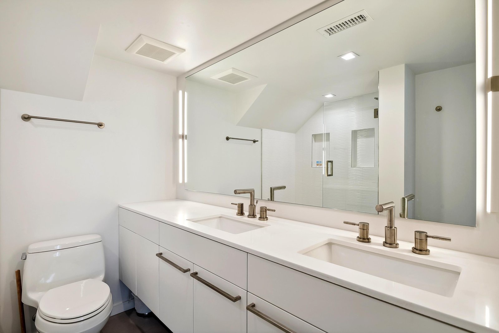 Step into your spa-like bathroom retreat with dual sinks, modern fixtures, and a spacious glass-enclosed shower—perfect for refreshing mornings and relaxing evenings.