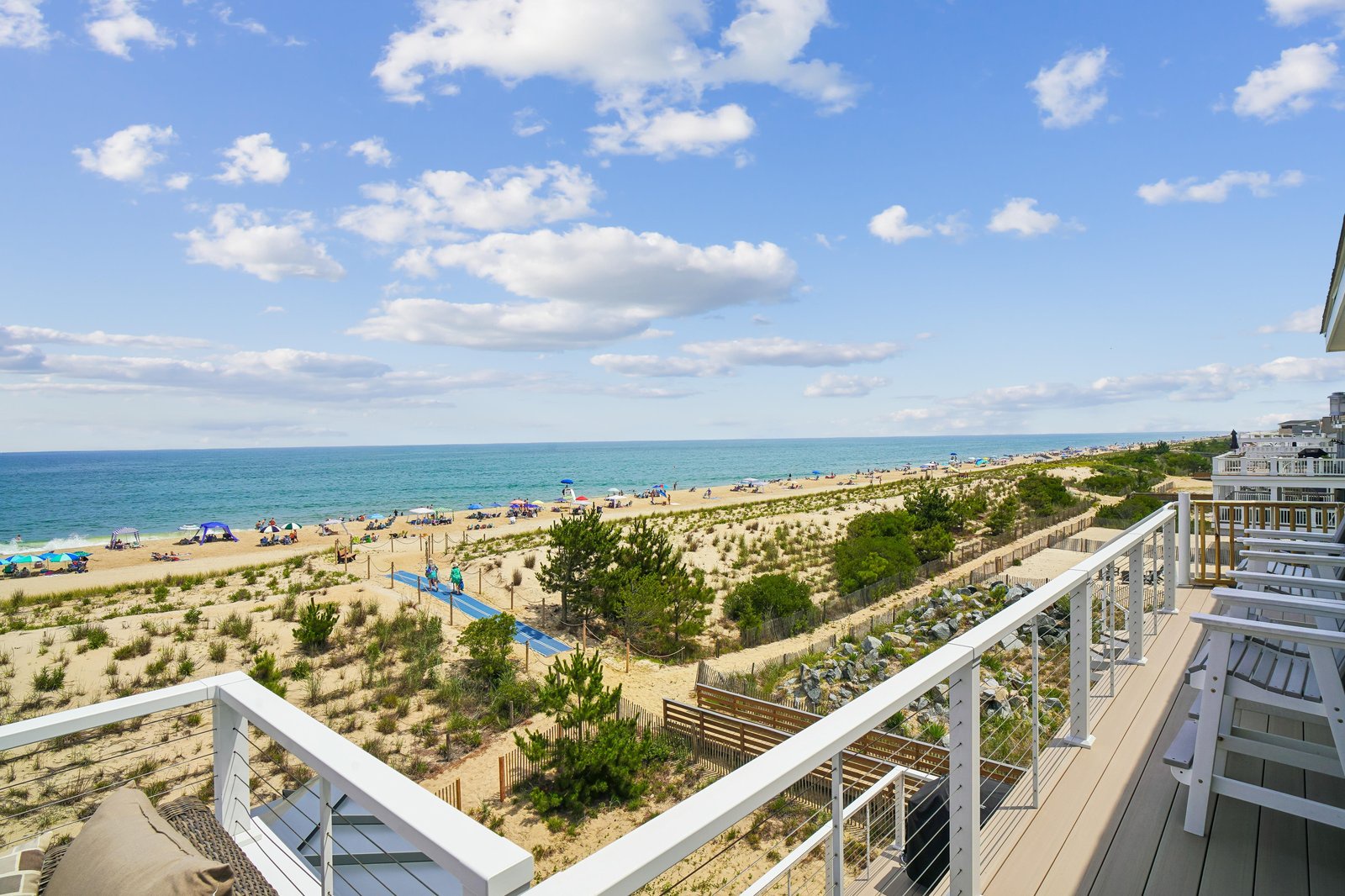 A stunning oceanfront property on the Delaware shore, where sandy beaches and coastal greenery frame the horizon. Your beachside retreat awaits just steps from the water.