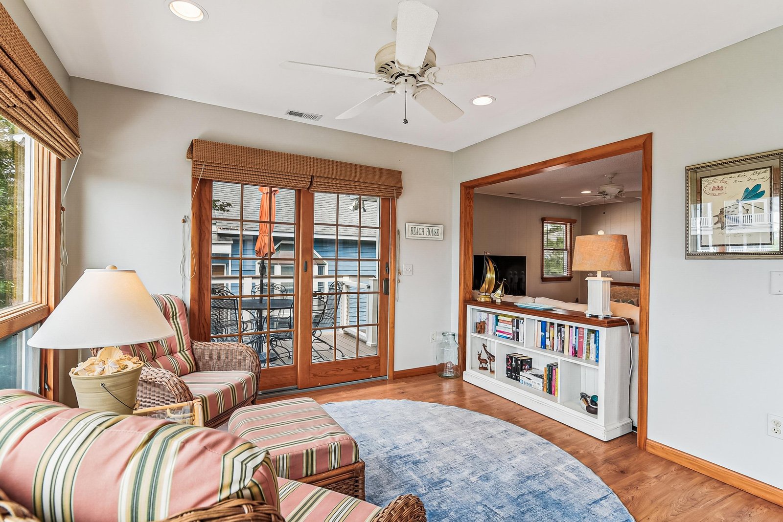 Settle into your cozy reading nook with a view of the water just beyond your private balcony, where warm wood tones and soft lighting invite you to unwind.