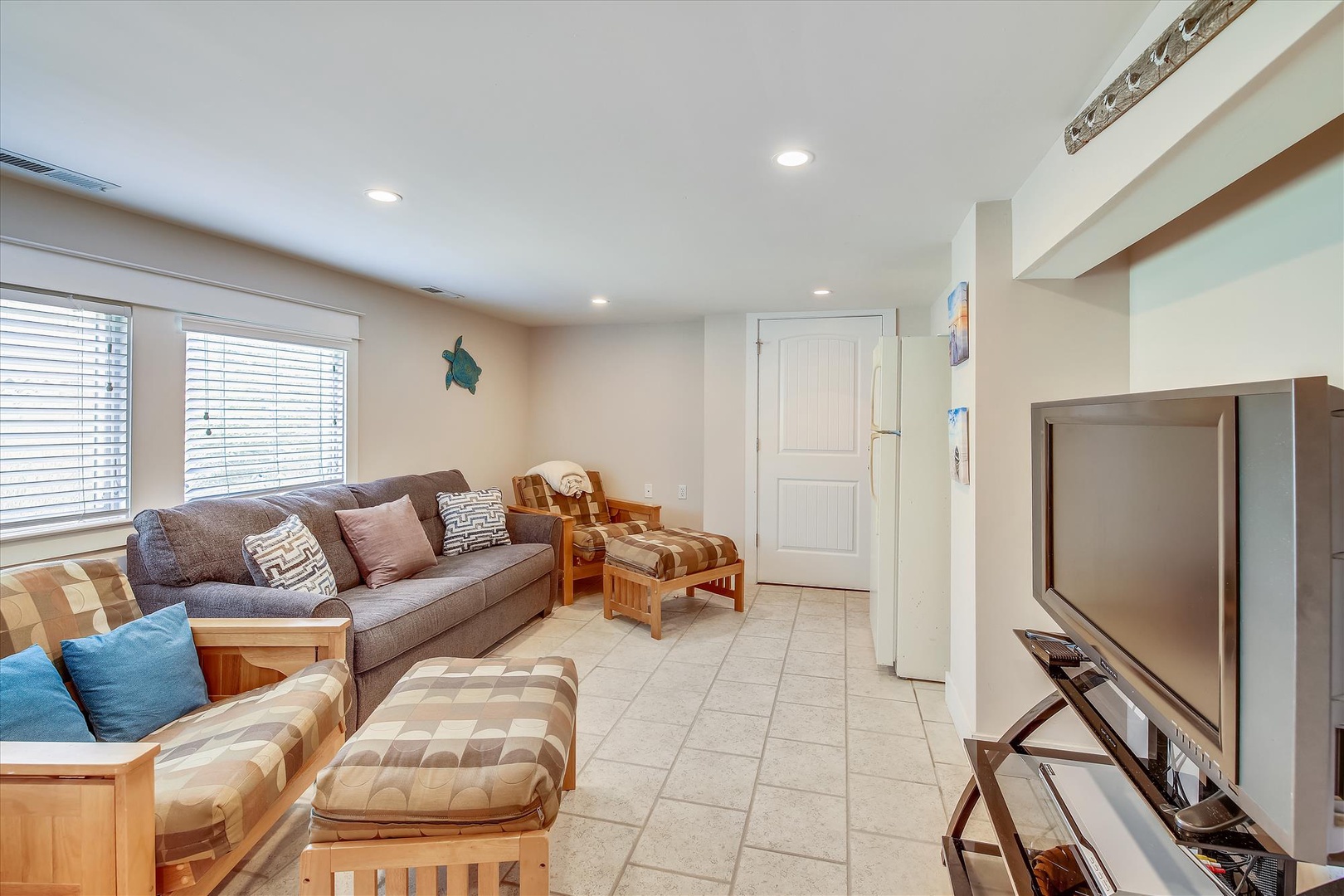 Gather with loved ones in this bright, inviting living space—complete with plush seating, coastal charm, and entertainment for relaxing days and cozy evenings.