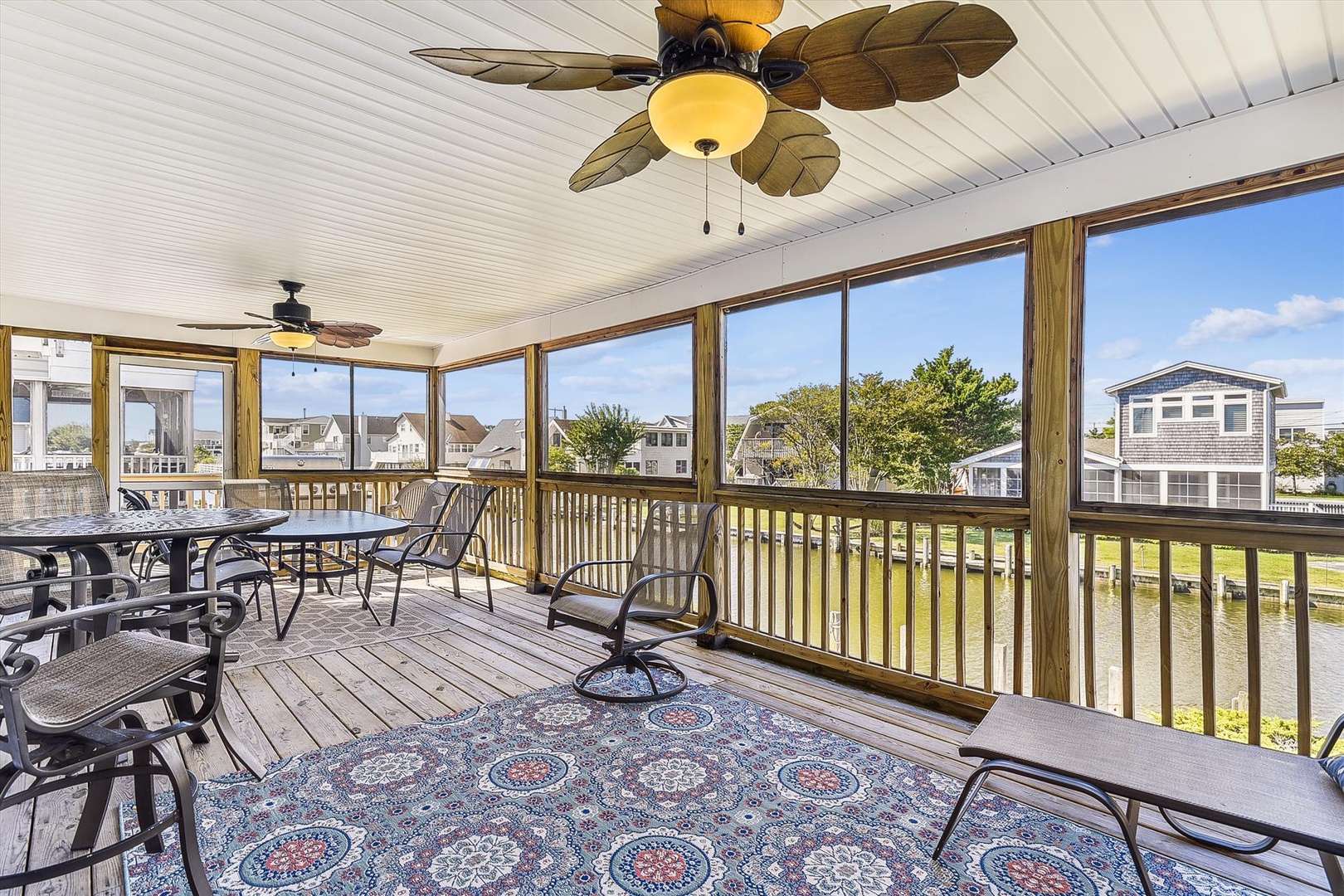 Relax in your private screened porch with ceiling fans and dining space, overlooking peaceful coastal neighborhood views—perfect for morning coffee or evening gatherings.