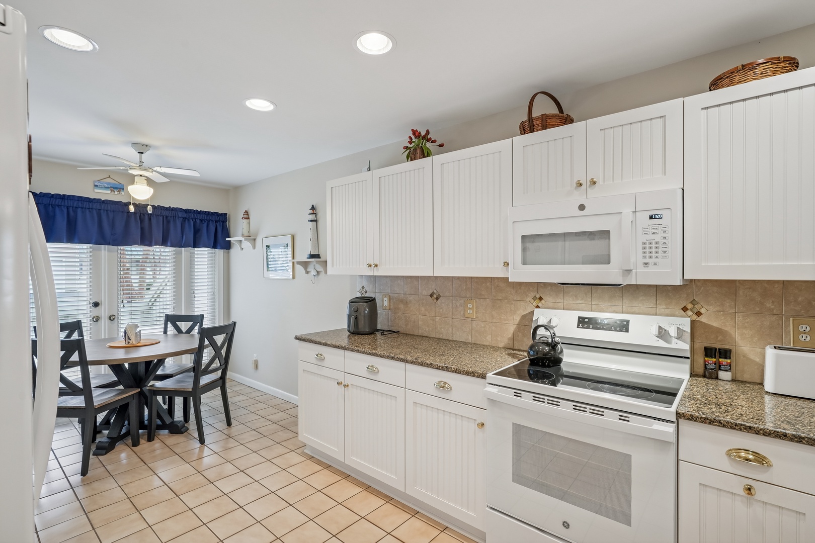 Your fully equipped kitchen features granite counters, modern appliances, and a cozy dining nook for memorable meals together.