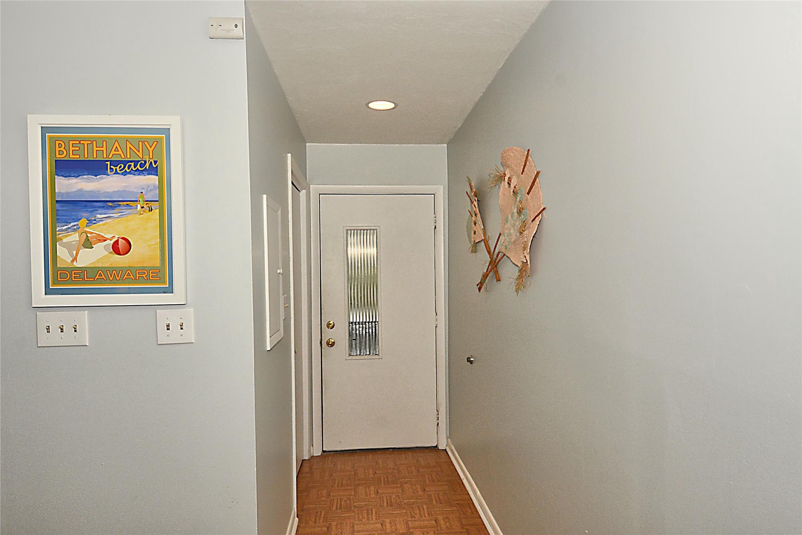 Your charming entryway welcomes you with coastal decor and warm wood floors, setting the perfect beach vacation mood.