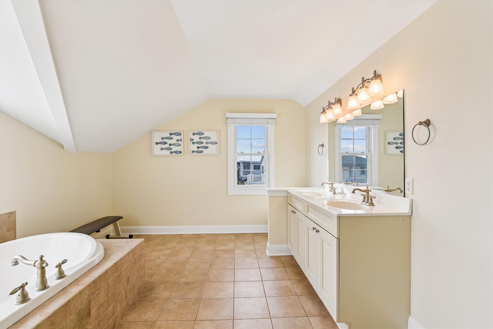 Unwind in this spacious bathroom featuring a soaking tub, dual vanity, and soft natural light—your perfect retreat after a day of adventure.