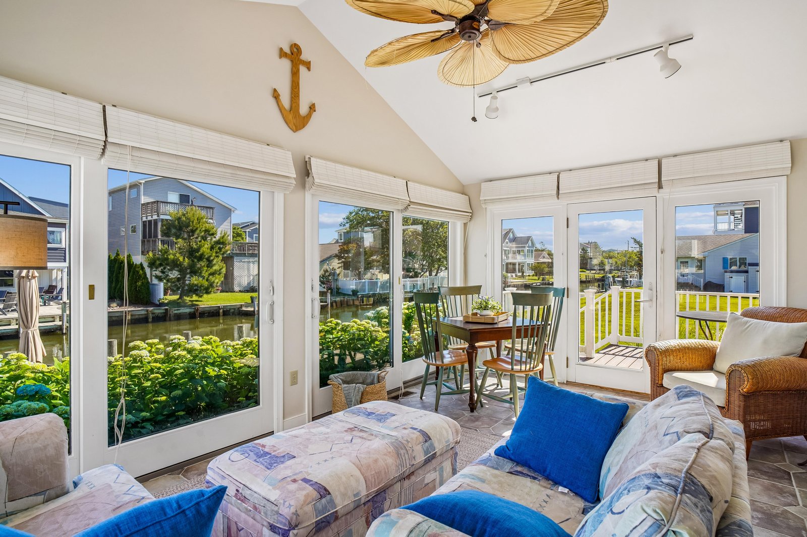 Relax in this bright, coastal-inspired living space with sweeping waterway views. Sink into comfortable seating, enjoy the tropical ceiling fan, and step out to your private deck overlooking the canal.