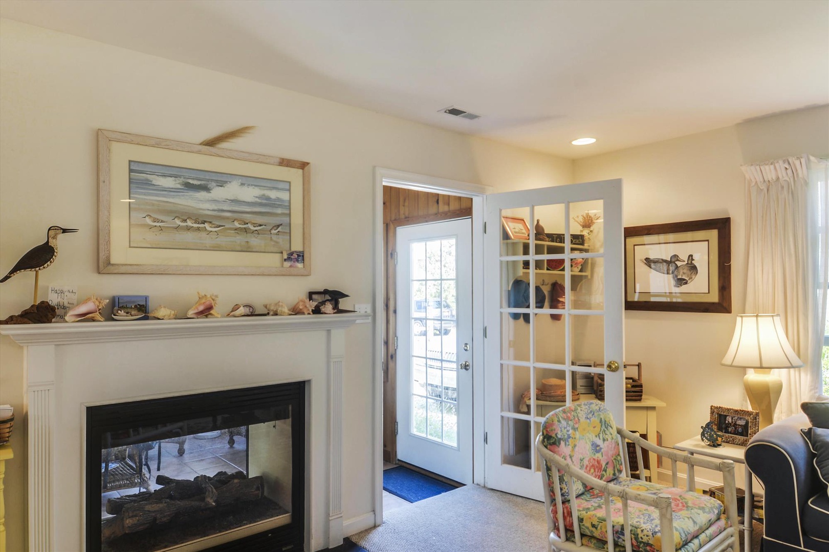 Relax by your cozy fireplace in this charming space with coastal décor, then step through French doors to your private entrance surrounded by natural light.