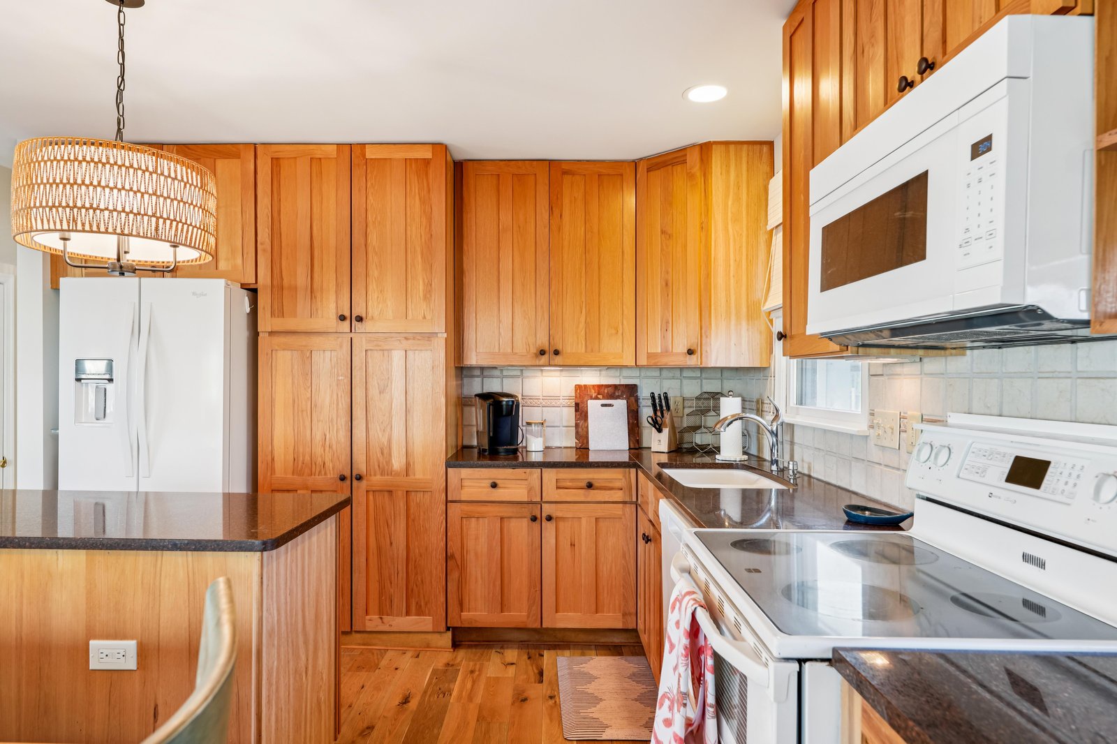 Your fully equipped kitchen features warm wood cabinetry, modern appliances, and everything you need to prepare meals during your stay.