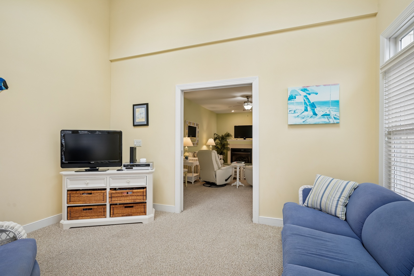 Relax in this cozy living space with plush blue seating and entertainment center, perfect for unwinding after your adventures.
