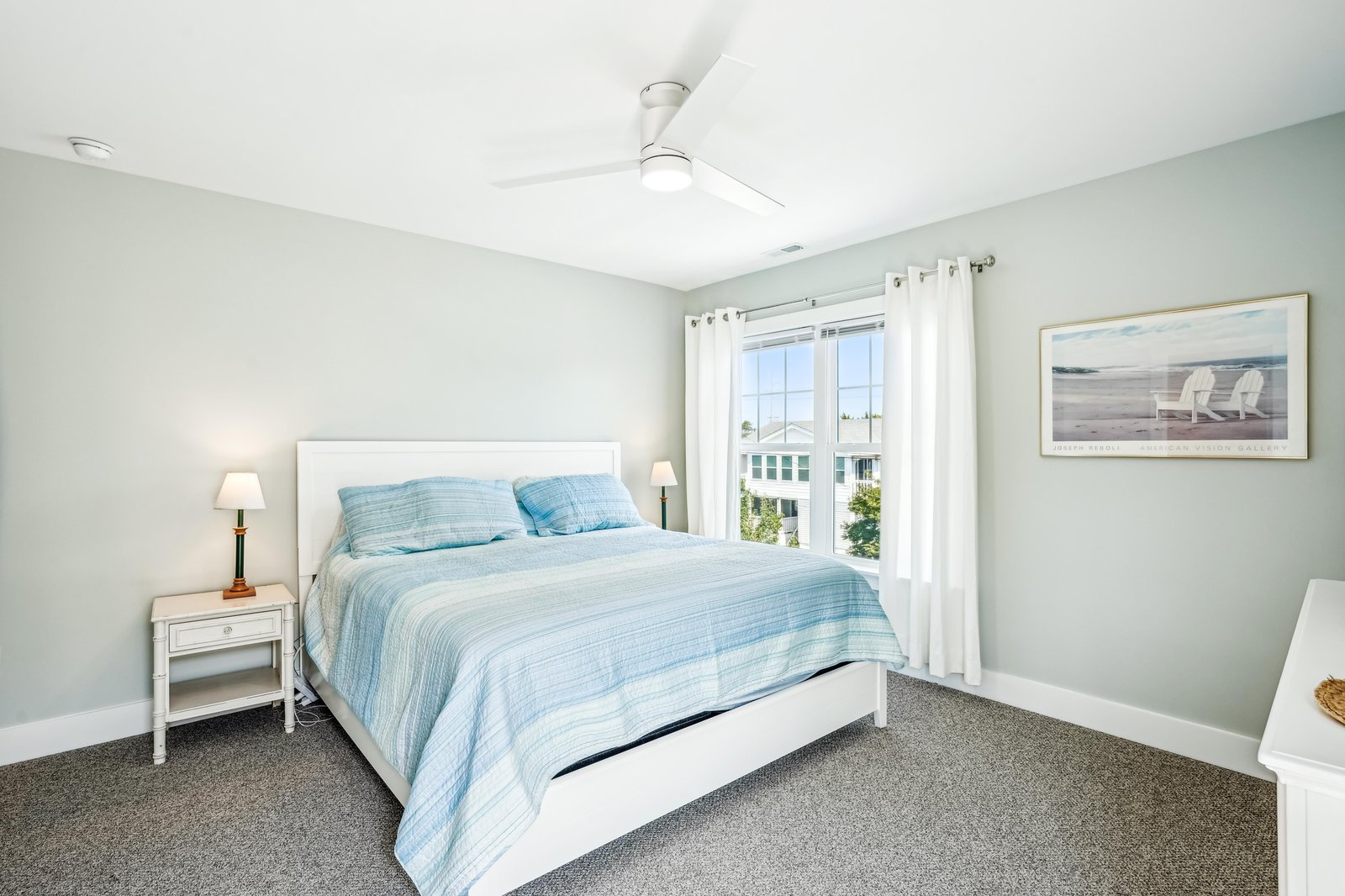 Rest easy in your coastal-inspired retreat with soft blue linens and crisp white furnishings that set the tone for peaceful mornings and restful nights.