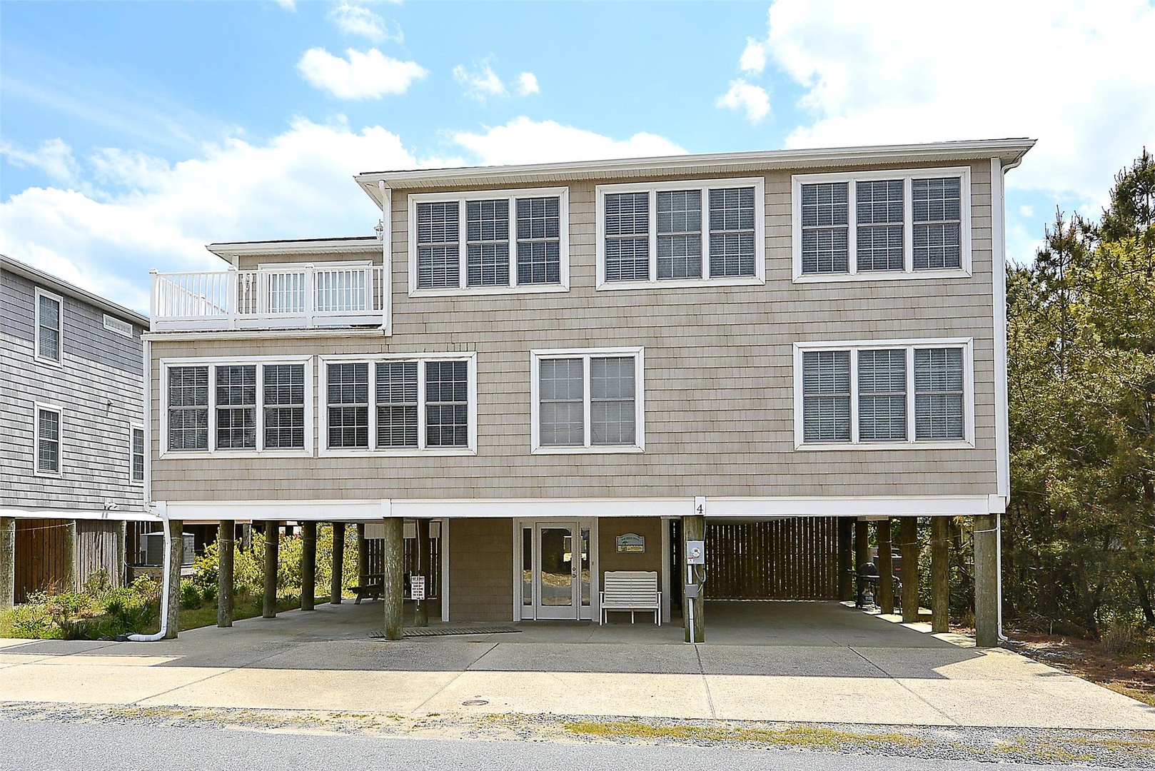 This elevated coastal property features generous parking beneath the main living areas and abundant windows that capture natural light and ocean breezes throughout the home.