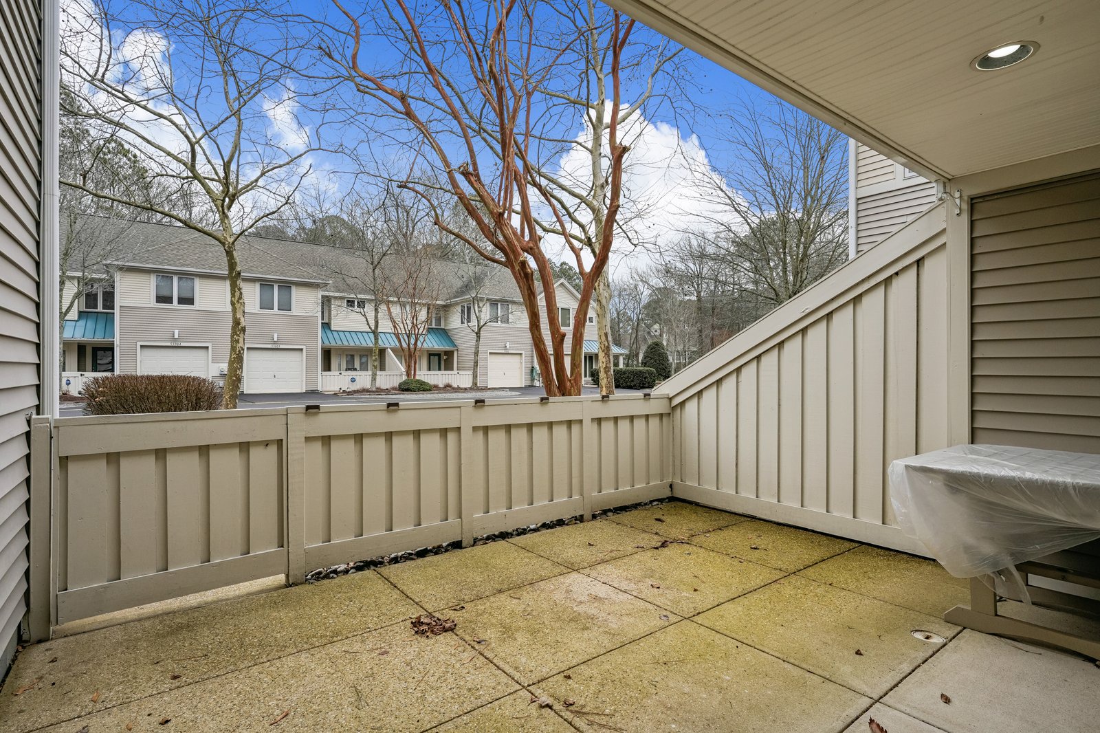 Step out to your private patio where morning coffee tastes better under the open sky. The fenced space offers peaceful moments with neighborhood views.