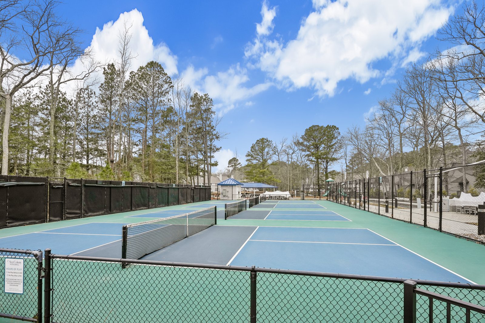 Professional tennis courts surrounded by mature trees offer the perfect setting for your morning match or afternoon game.