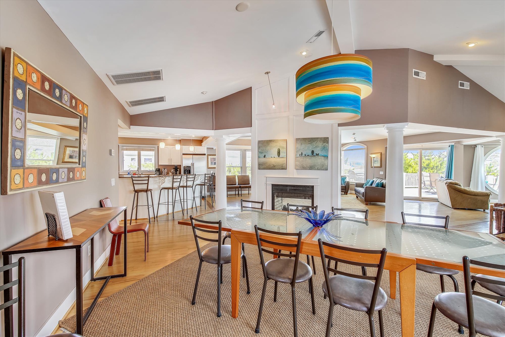 Gather around this inviting dining space, where coastal colors and natural light create the perfect setting for your morning coffee or evening meals. The open layout connects you to the kitchen and living areas, making every moment feel effortlessly socia