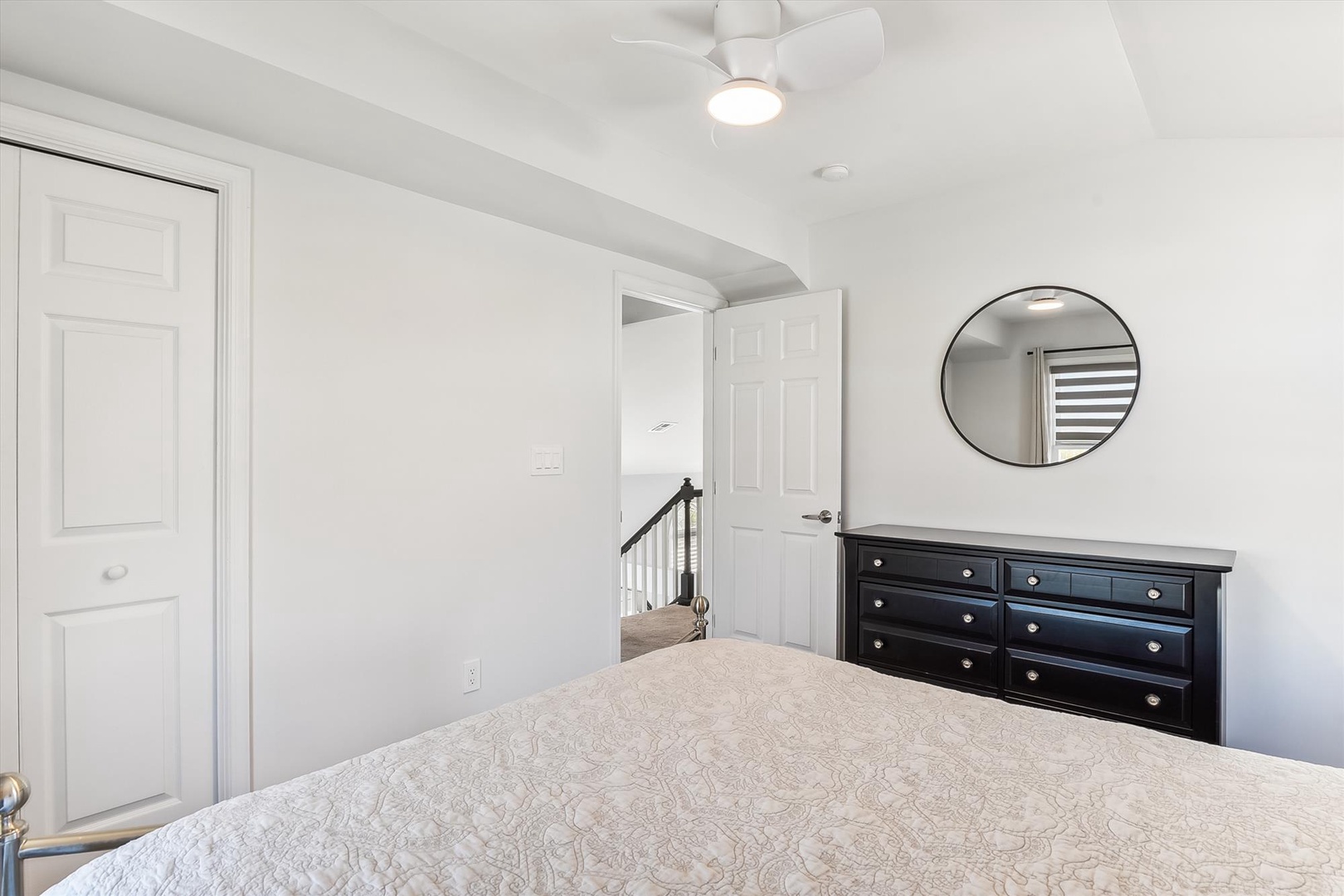Relax in your peaceful bedroom retreat with plush bedding, ample dresser space, and a ceiling fan to keep you cool and comfortable.