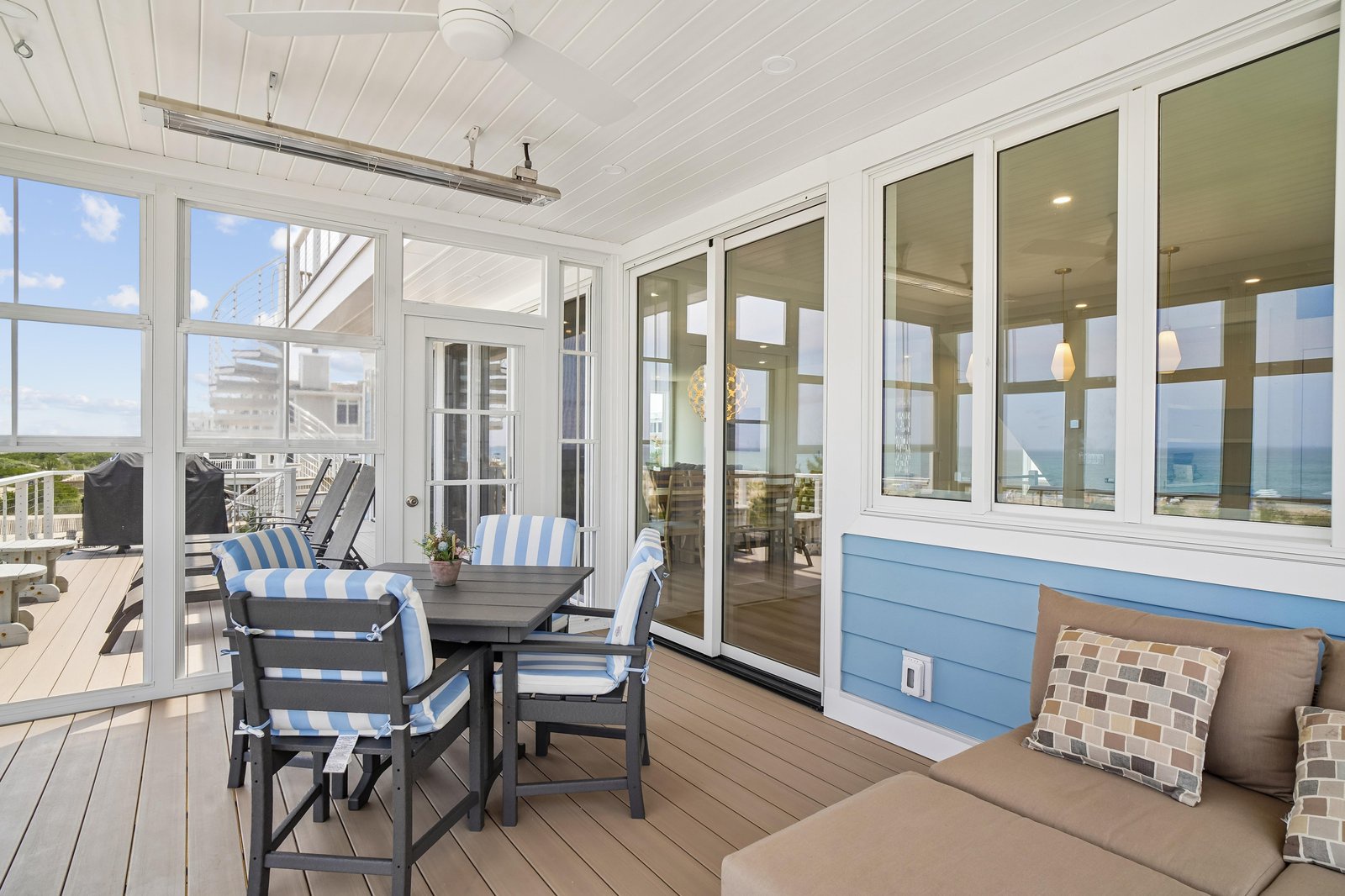 Settle into this breezy screened porch and breathe in the ocean air. With comfy seating and sweeping coastal views, it's your perfect spot to unwind with morning coffee or evening conversation.
