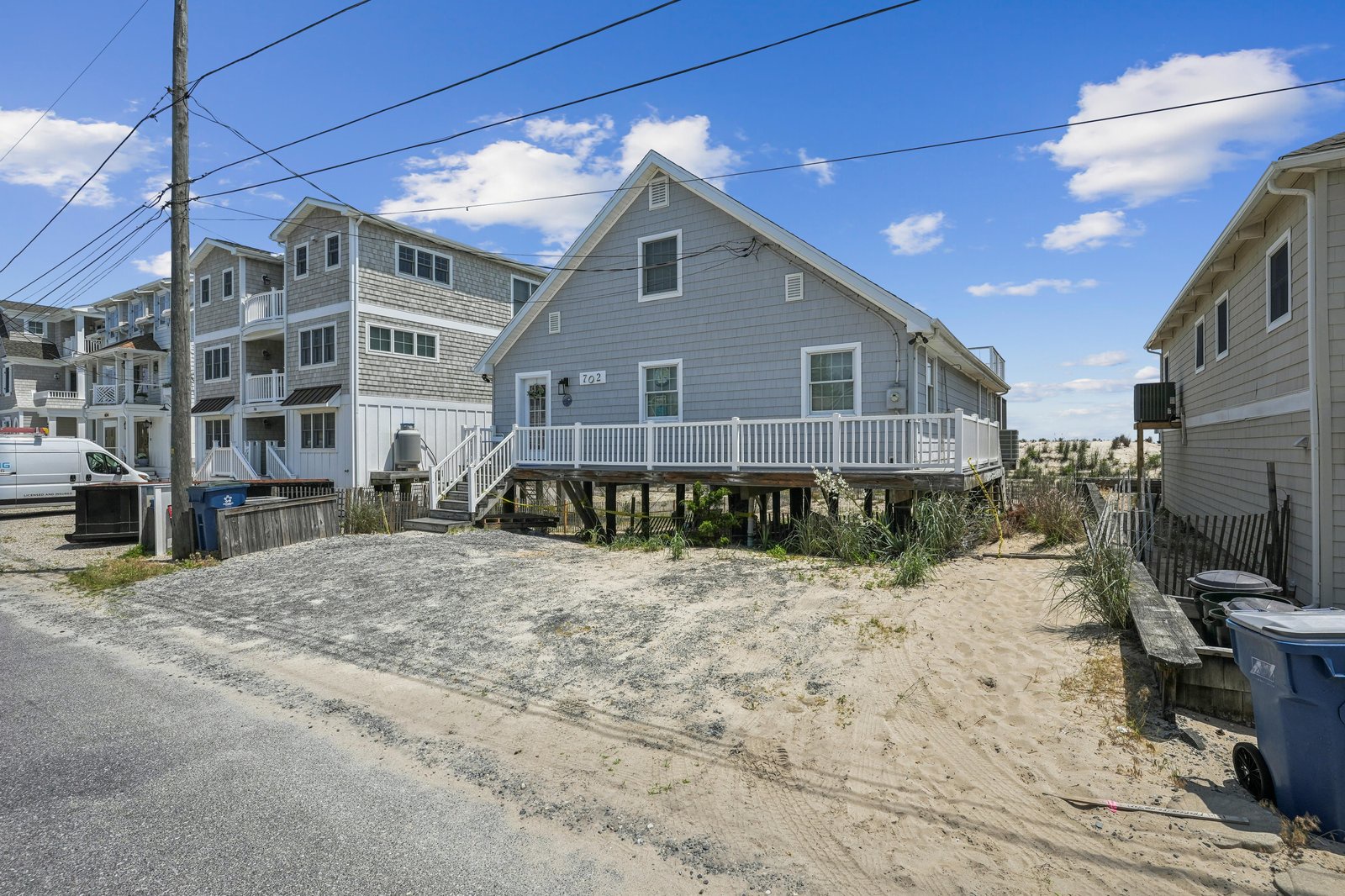 A coastal beach property elevated on stilts with direct sand access in a quiet seaside neighborhood.