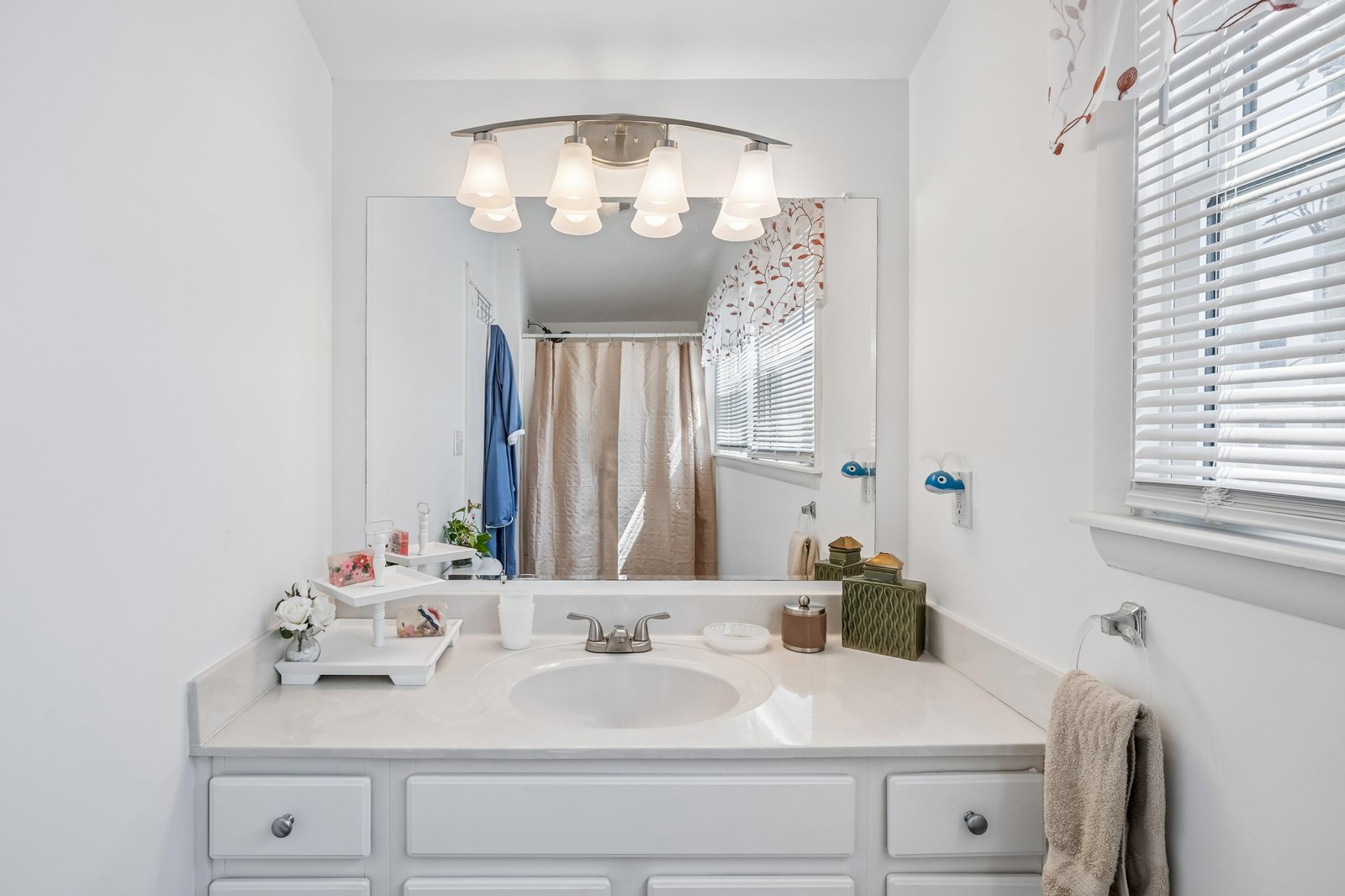 Refresh in your bright, stylish bathroom with soft lighting, ample counter space, and thoughtful decor—designed to make your morning routine a relaxing part of your getaway.