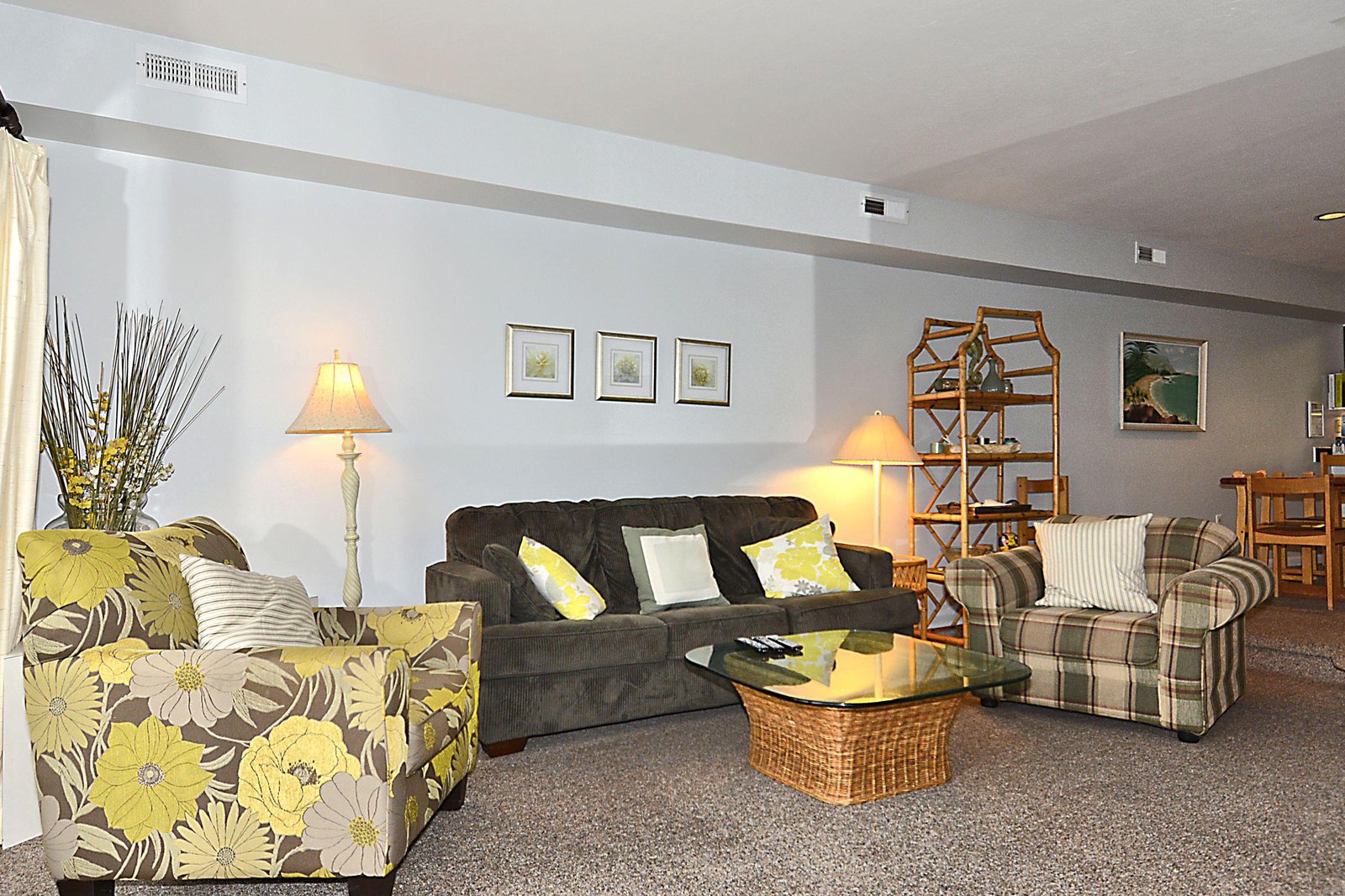 Relax in your spacious living room, where comfortable seating, soft lamps, and cheerful yellow accents create a warm, inviting space to unwind after your adventures.