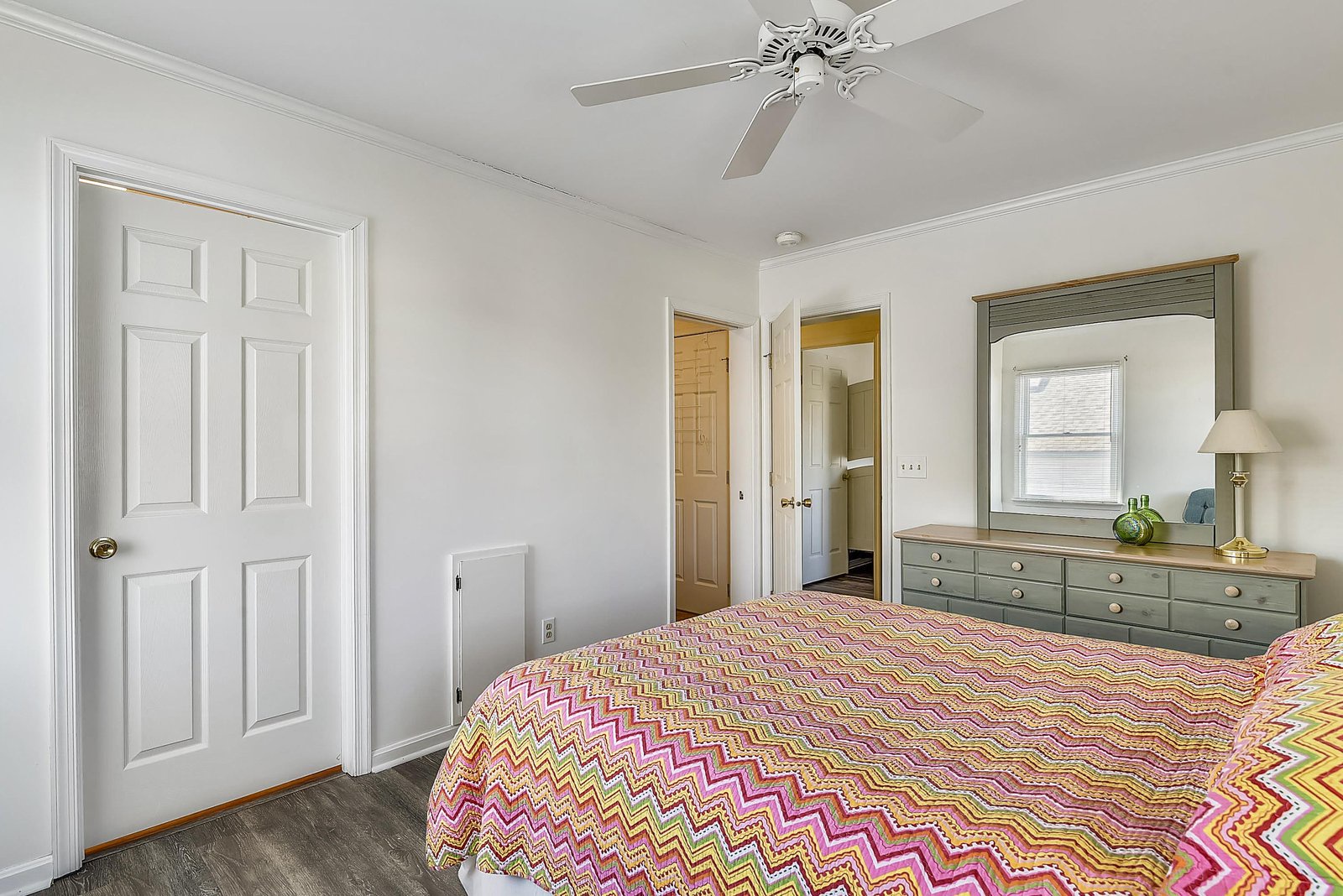 Slip under the cheerful chevron bedding and let the gentle ceiling fan breeze lull you into restful sleep. Your dresser awaits for easy unpacking.