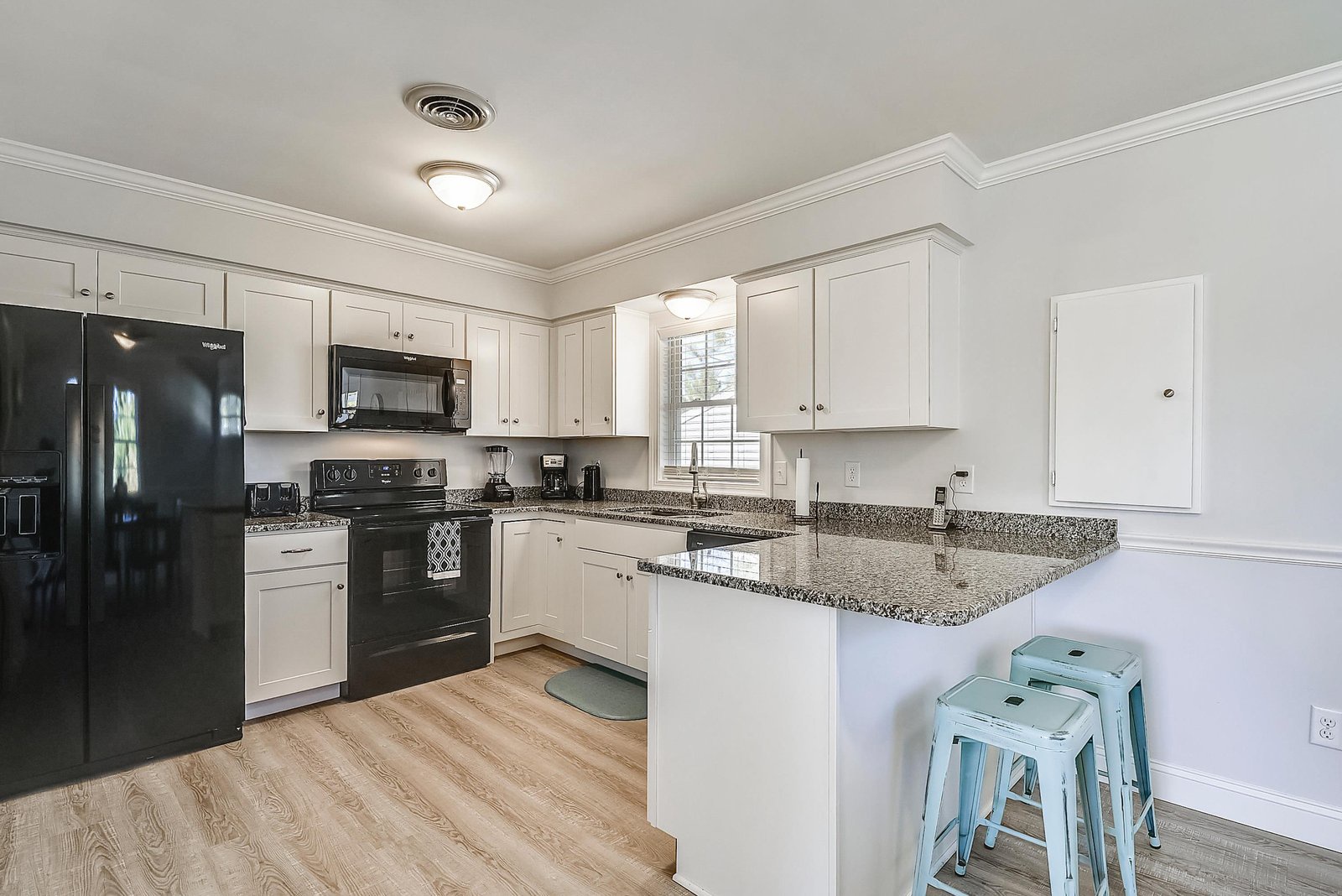Your bright, fully equipped kitchen invites you to whip up morning coffee or a home-cooked meal. Granite countertops, modern appliances, and a cozy breakfast bar create a space that feels both practical and welcoming.
