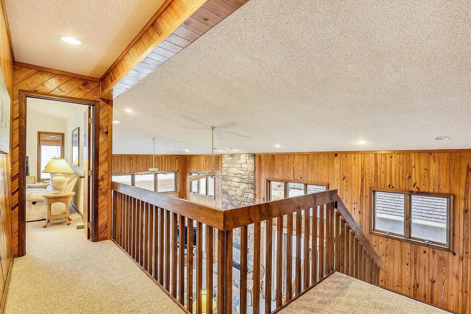 Step into this warm, wood-paneled retreat where vaulted ceilings and natural light create an inviting mountain escape. Your private hallway leads to cozy spaces perfect for unwinding after a day of adventure.