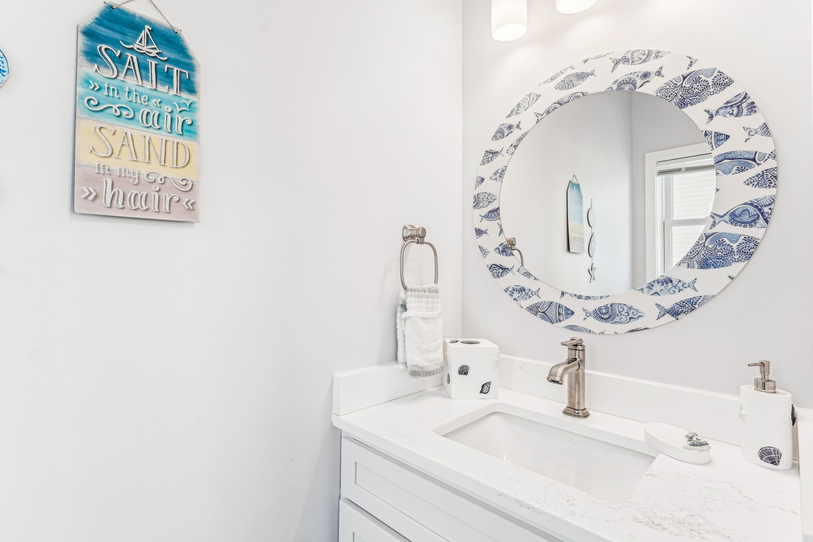 Freshen up in your bright coastal-themed bathroom, where beachy accents and a sparkling vanity invite you to unwind and prepare for your day by the sea.