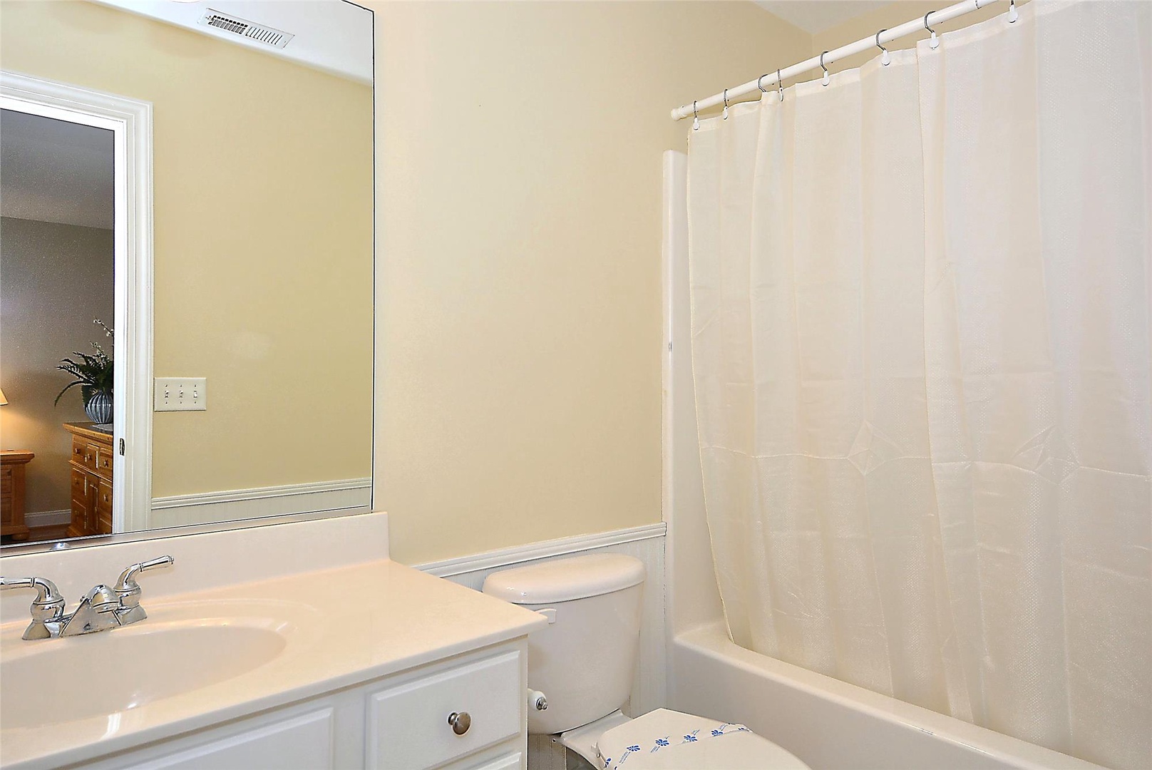 Step into your private bathroom with a full tub-shower combo, soft neutral tones, and plenty of counter space for all your essentials.