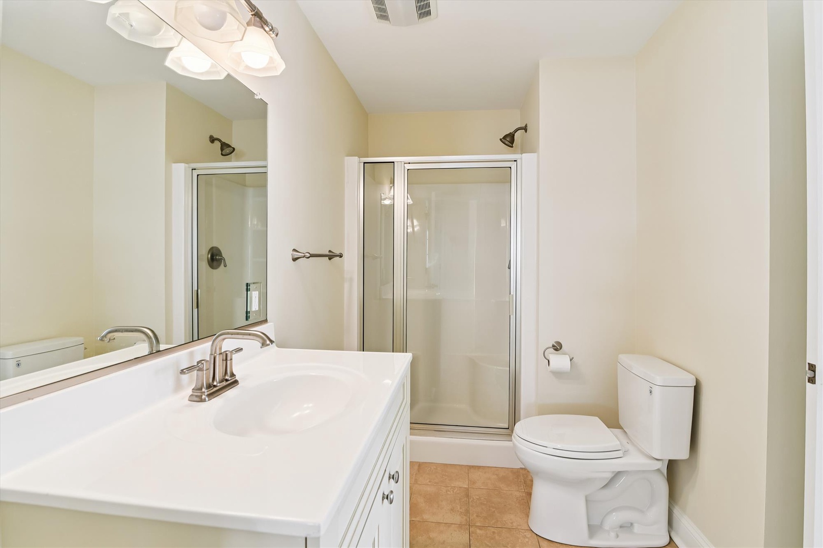 Your private bathroom features a spacious walk-in shower, gleaming fixtures, and plenty of counter space to settle in and feel right at home.