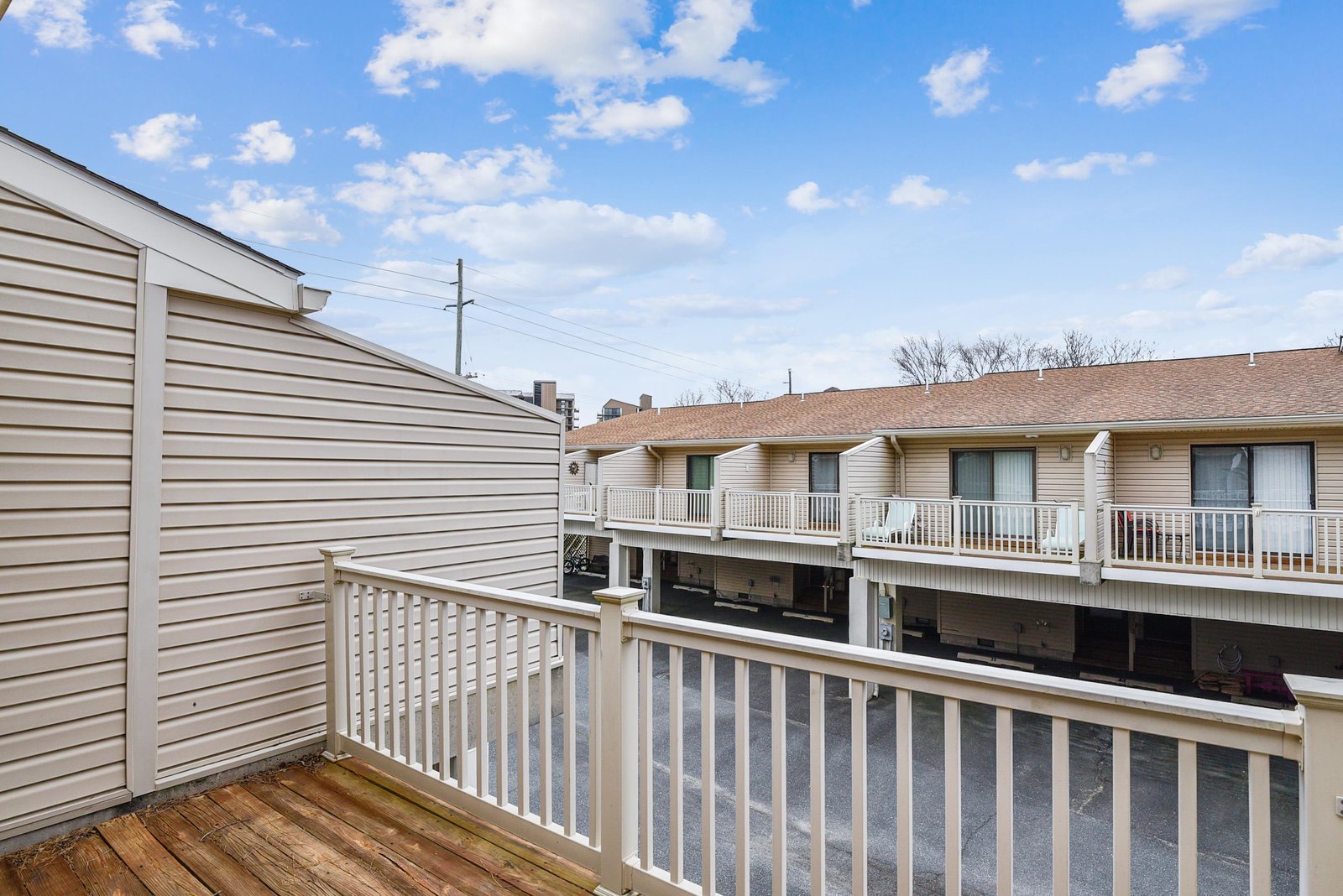 Your private balcony overlooks a quiet residential setting, offering open skies and a peaceful spot to enjoy morning coffee or evening breezes.