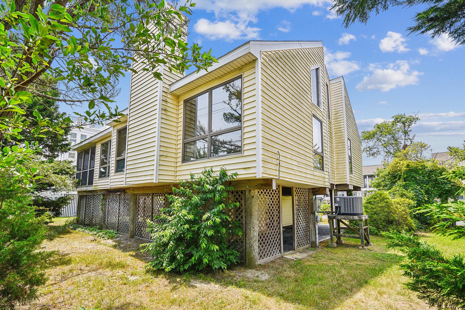 Modern beachside retreat with elevated design and natural garden surroundings, nestled in a peaceful coastal neighborhood perfect for your seaside escape.