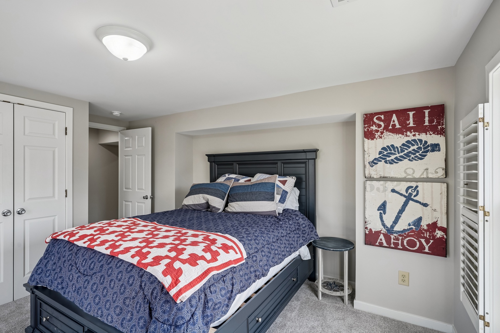 Drift off to dreams in this cozy nautical bedroom with crisp linens and maritime charm.