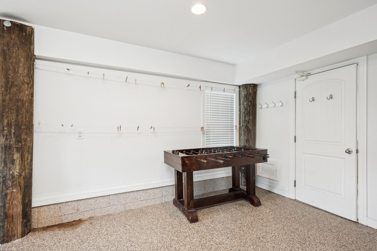 Challenge your friends to foosball in this inviting game room, complete with rustic wood accents and plenty of wall hooks for your gear.