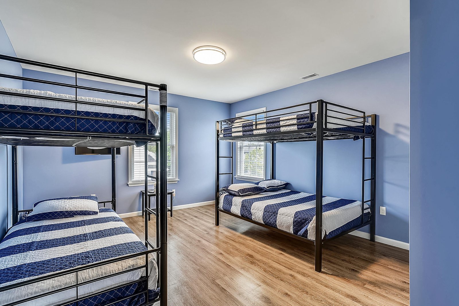Your spacious bunk room offers comfortable sleeping for multiple guests, with crisp linens and soft morning light flowing through the windows.