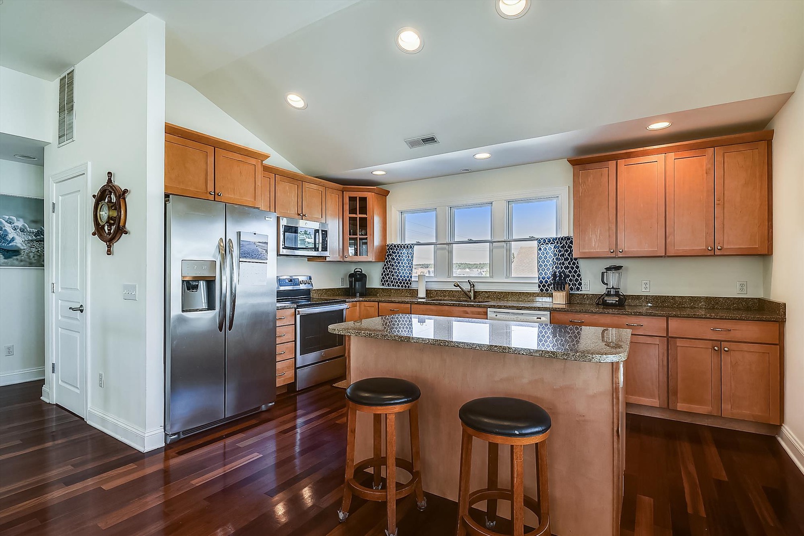 Your fully equipped kitchen features granite countertops, stainless steel appliances, and a breakfast bar where you can enjoy morning coffee with stunning views.