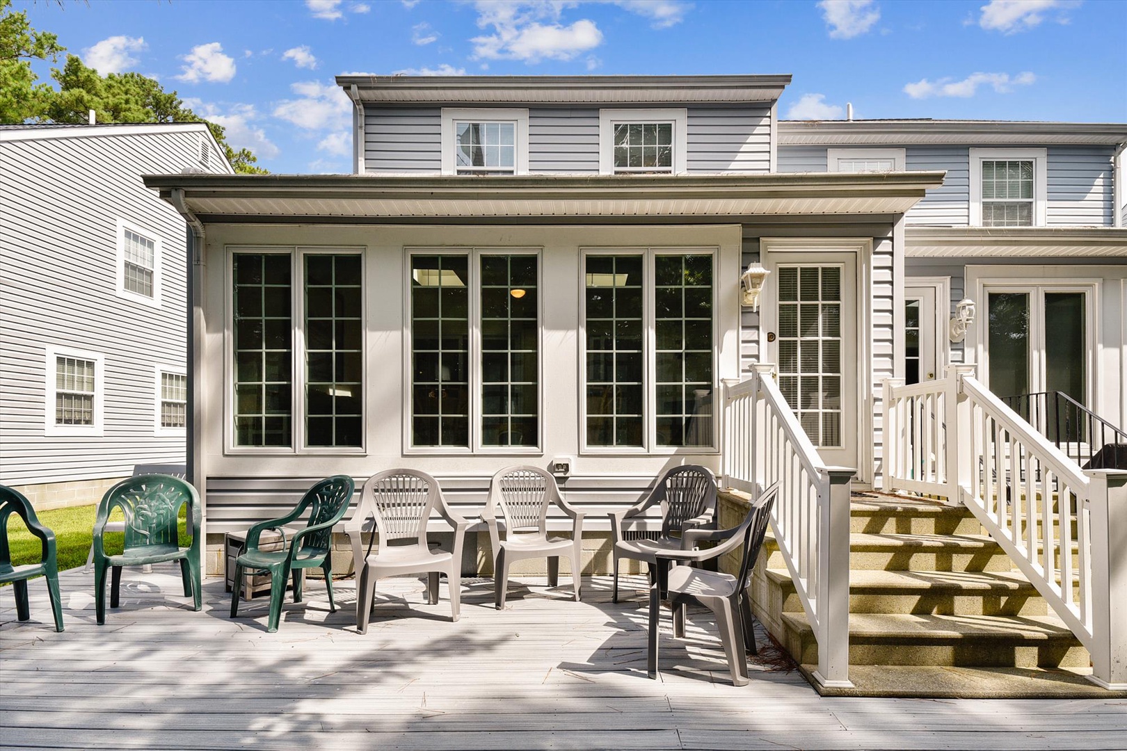 Your private deck awaits with comfortable seating for alfresco dining, morning coffee, or evening relaxation under open skies. French doors invite you to seamlessly blend indoor comfort with outdoor charm.
