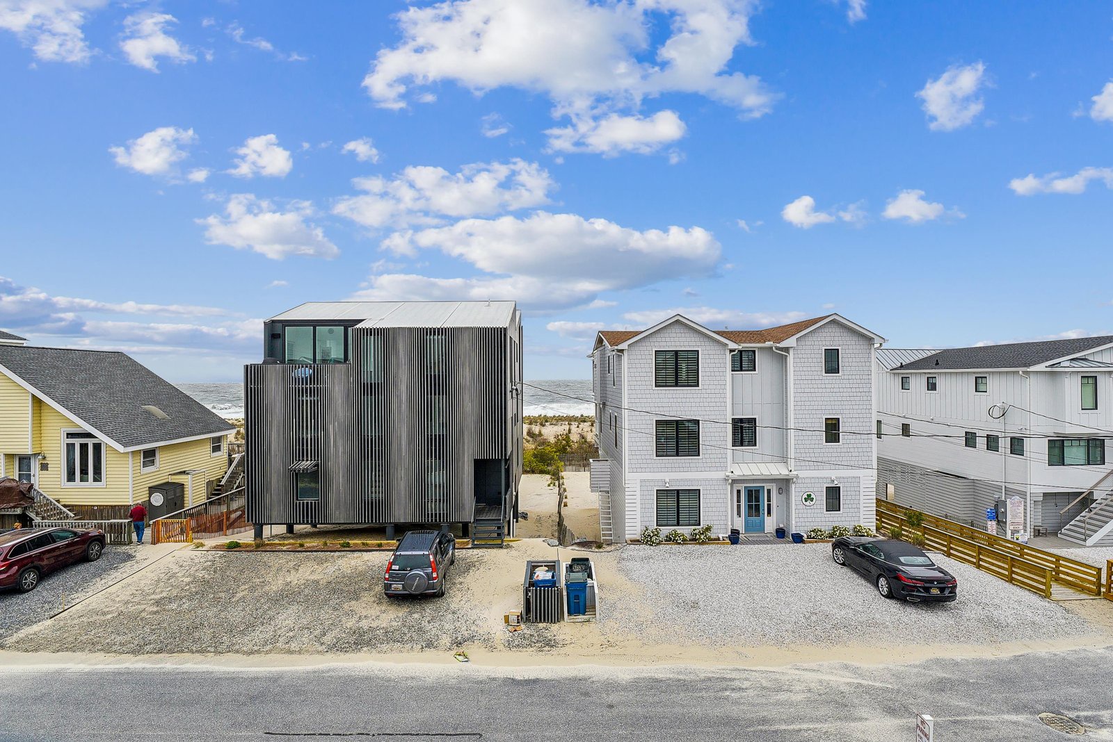 The property sits within a residential coastal neighborhood featuring beach homes and convenient street parking, marking the start of your seaside retreat.