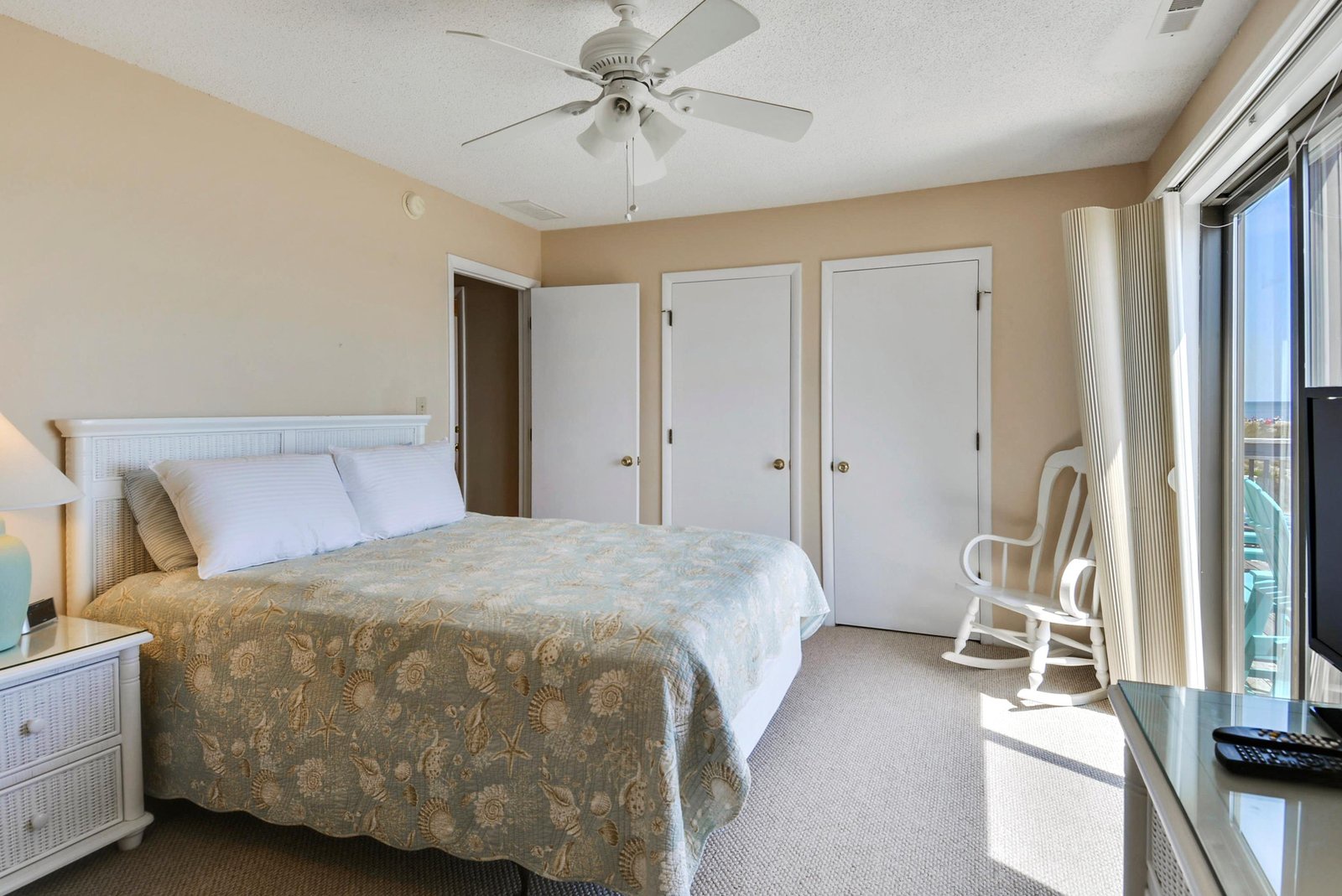 Sink into crisp linens after a day by the water. Your bedroom offers plenty of storage and opens to a balcony with views beyond.