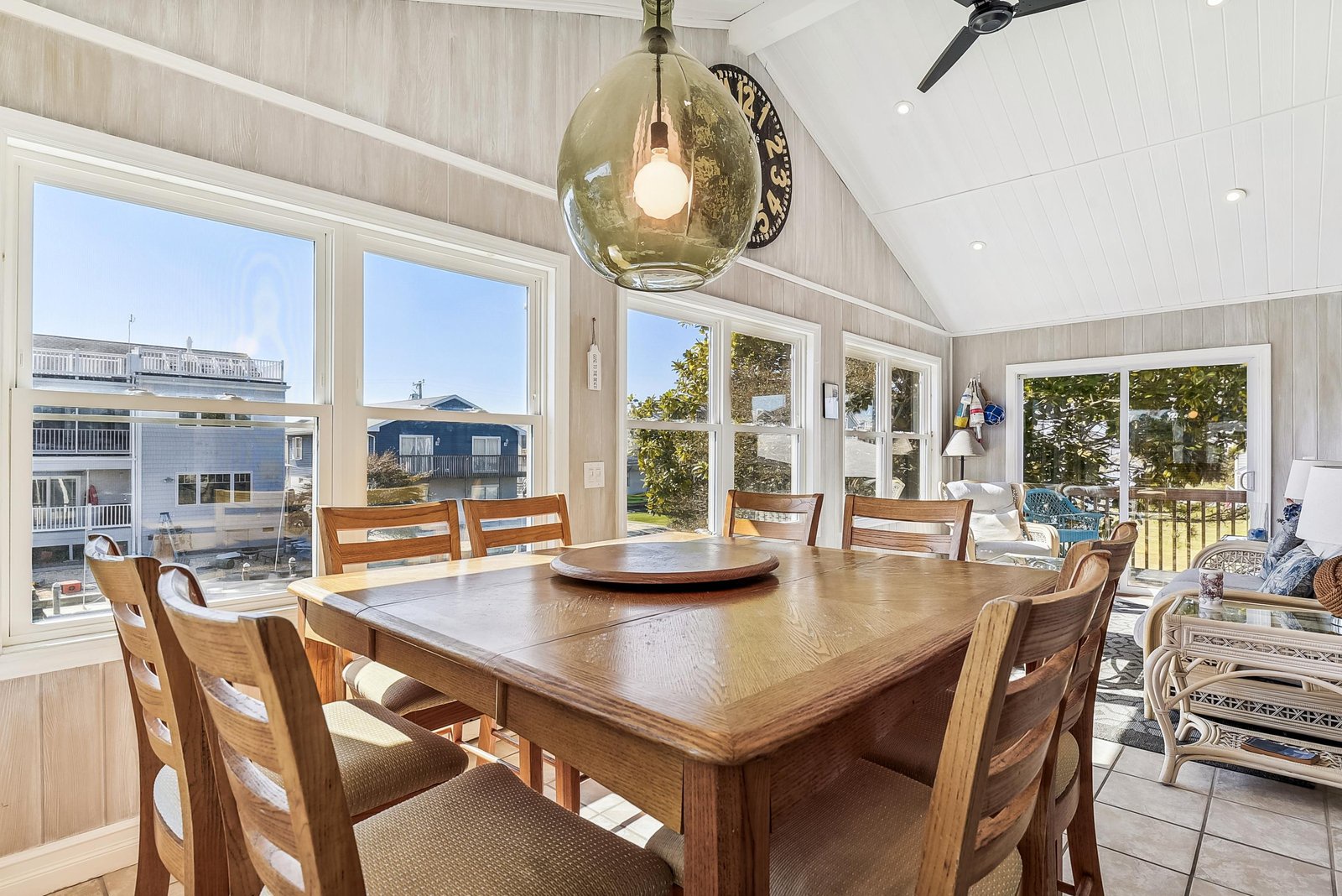 Gather around this spacious dining table, where sunlight pours through floor-to-ceiling windows and your group can share meals while taking in waterfront views and coastal air.