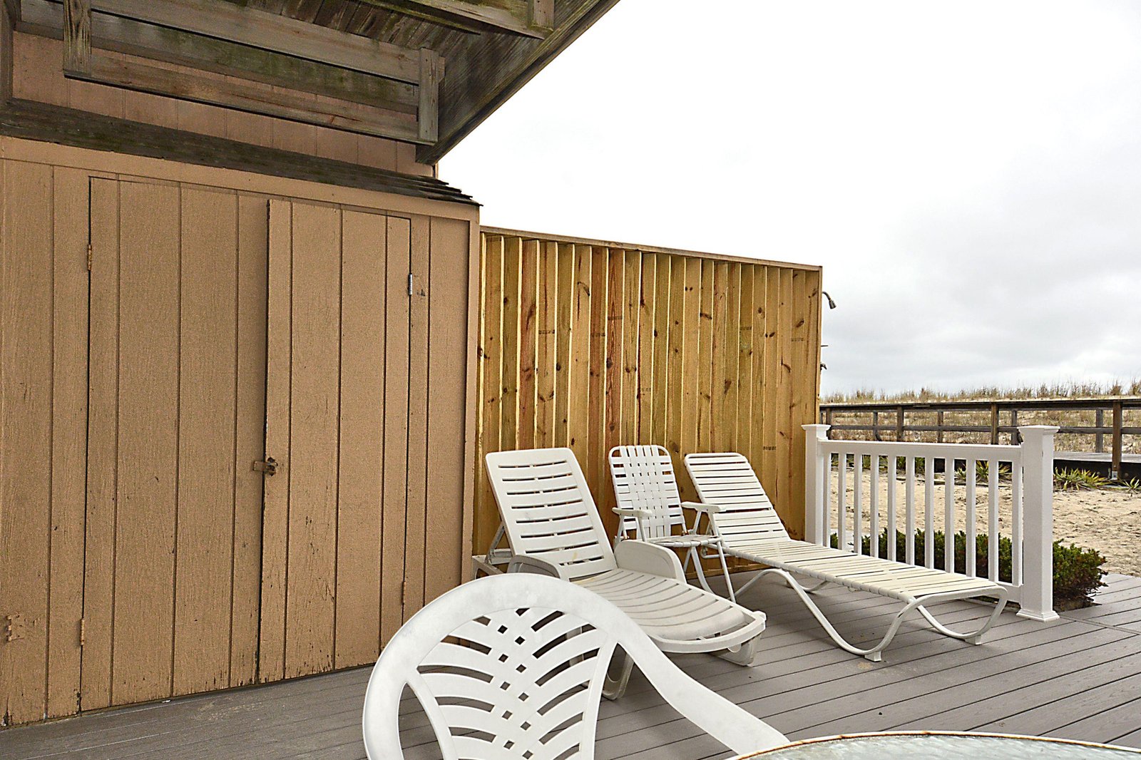 A spacious deck overlooks a natural coastal landscape, providing an ideal spot to unwind with ocean breezes and scenic views.