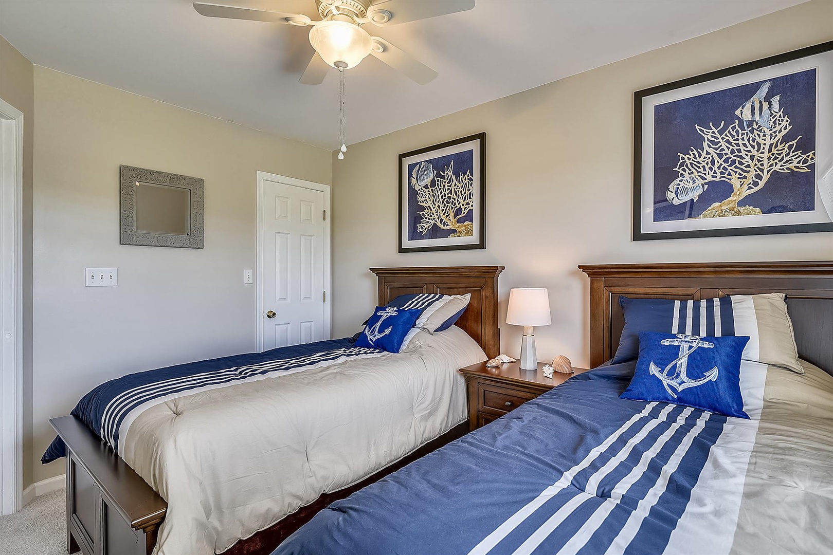 Settle into your nautical-themed twin bedroom, where coastal artwork and crisp linens invite restful nights after days exploring the shore.