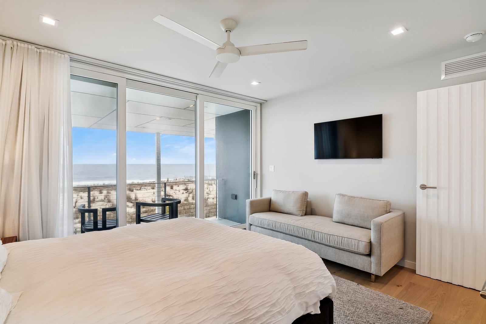 Wake up to coastal serenity in your bright, airy bedroom, where sliding doors open onto your private balcony overlooking the beach. Soft linens, a cozy sofa, and gentle sea breezes make this your peaceful retreat.