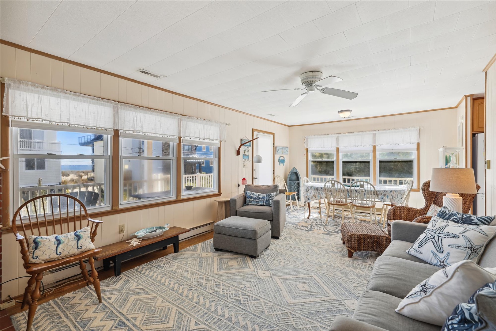 Sink into the plush coastal seating and feel the ocean breeze through your windows—your bright, airy haven awaits with charming nautical touches and room to gather.