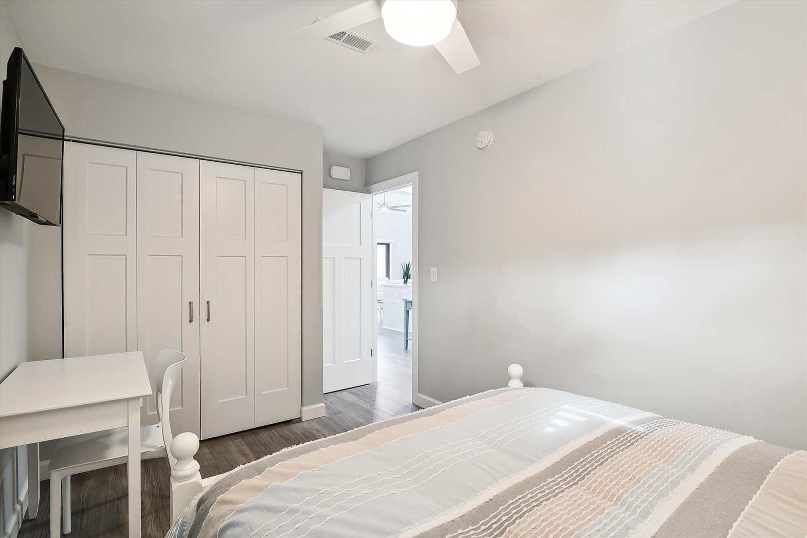 Relax in your bright, airy bedroom with ceiling fan and ample closet storage. Soft linens and modern touches ensure your comfortable stay in this peaceful retreat.
